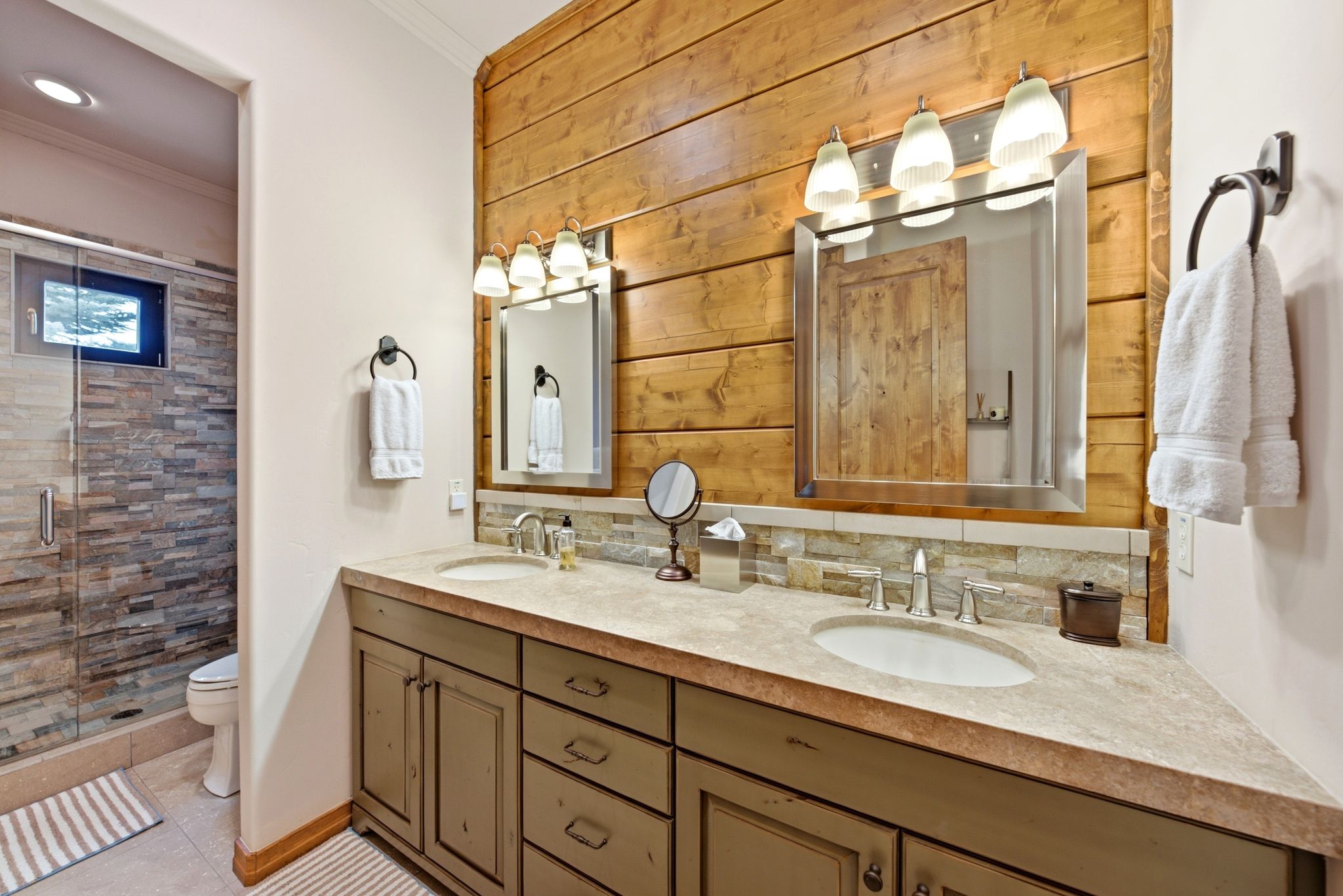 Dual vanity featuring integrated sinks and a stone-finish countertop