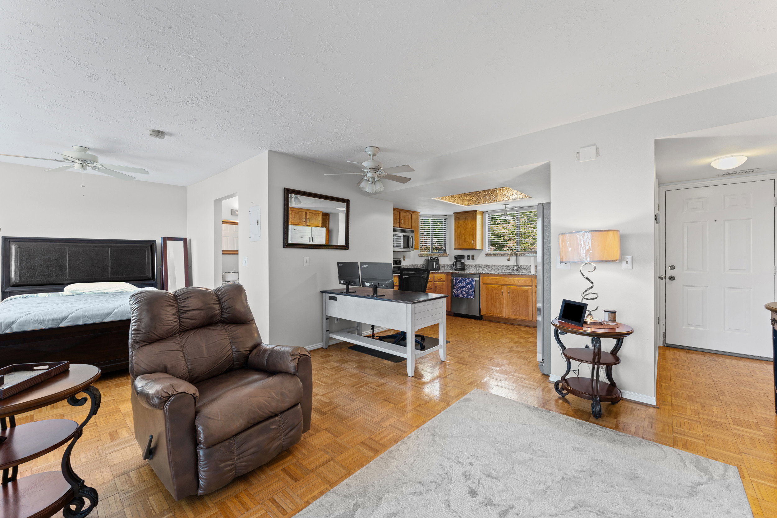 Open concept living area featuring wood-finish parquet flooring throughout