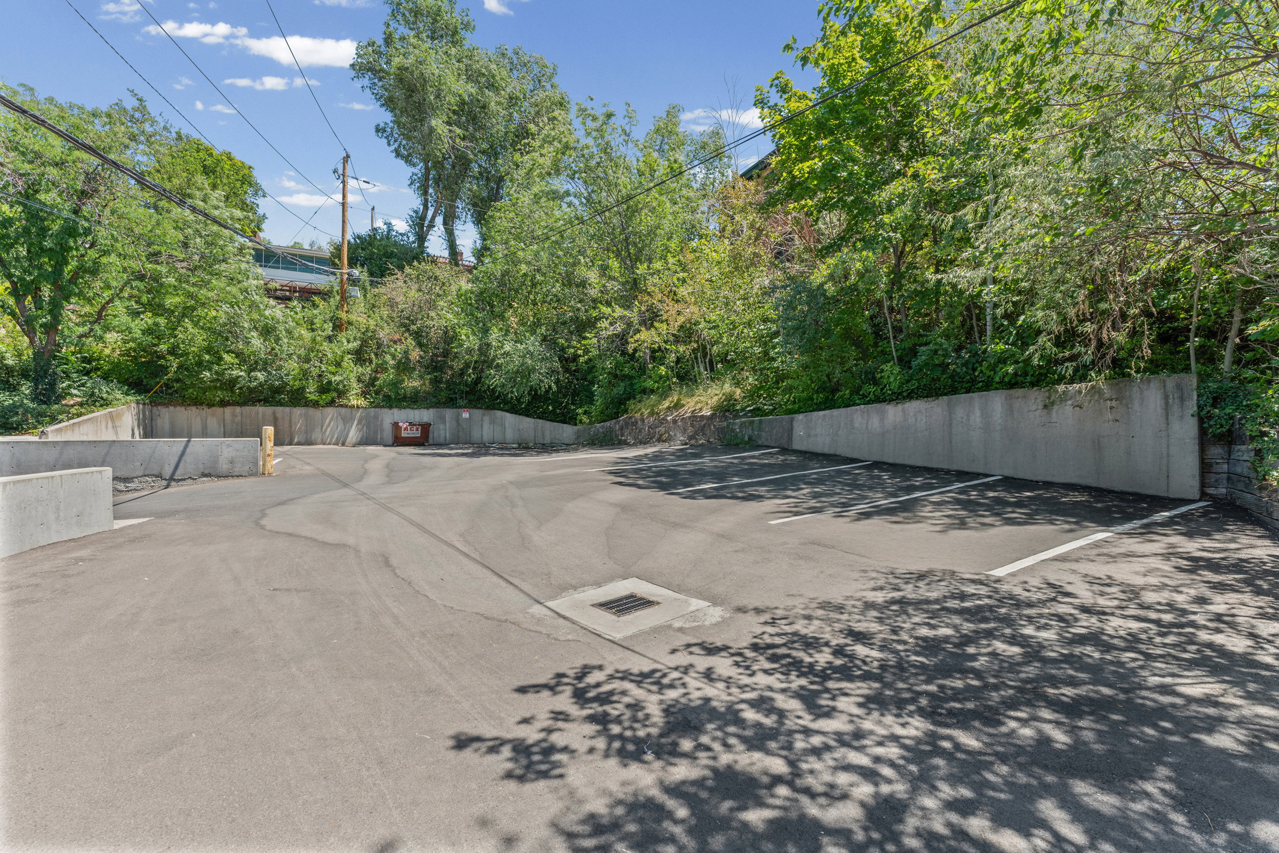 Paved parking area with concrete retaining walls and marked parking spaces