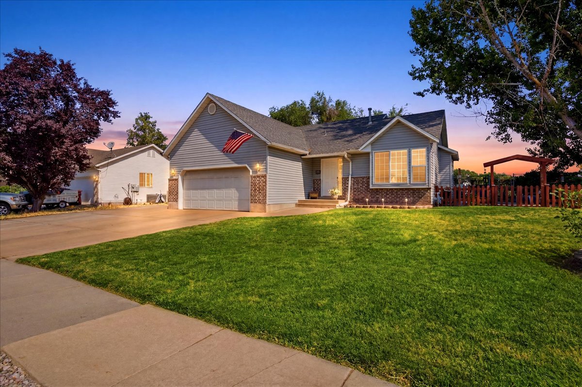 Gray siding exterior with brick accents and a two-car garage