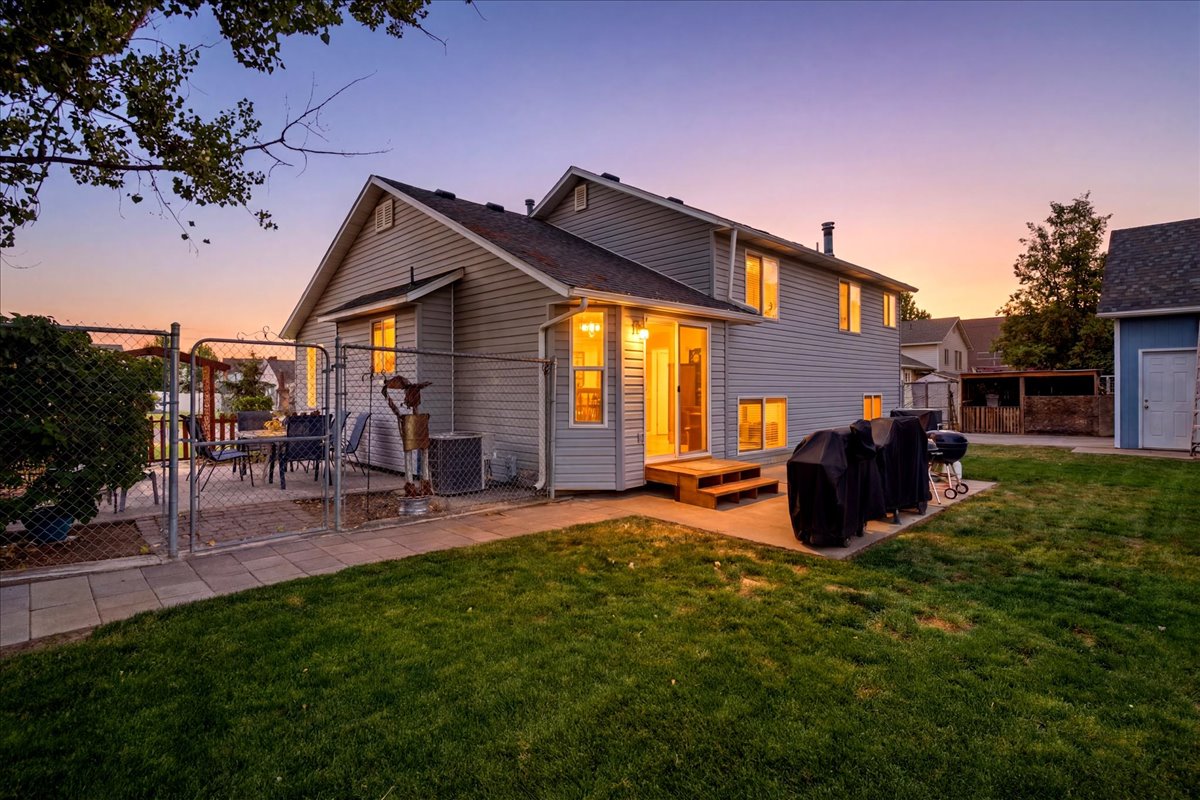 Vinyl-sided exterior with dual-pane windows and a multi-level deck