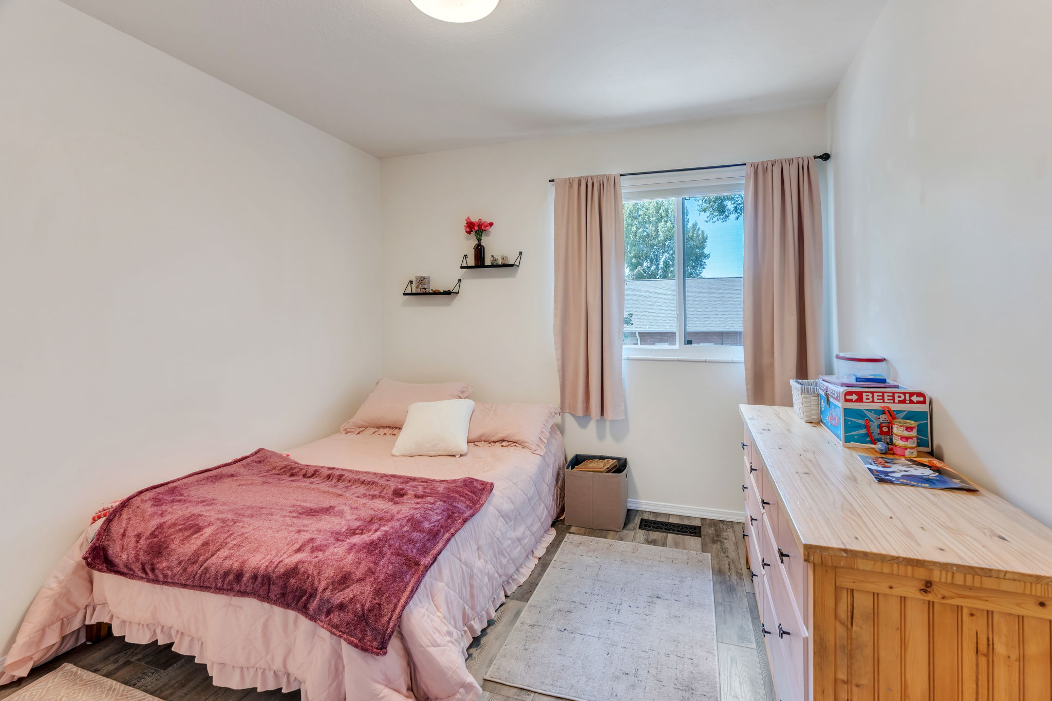 Room featuring wood-finish flooring and white walls
