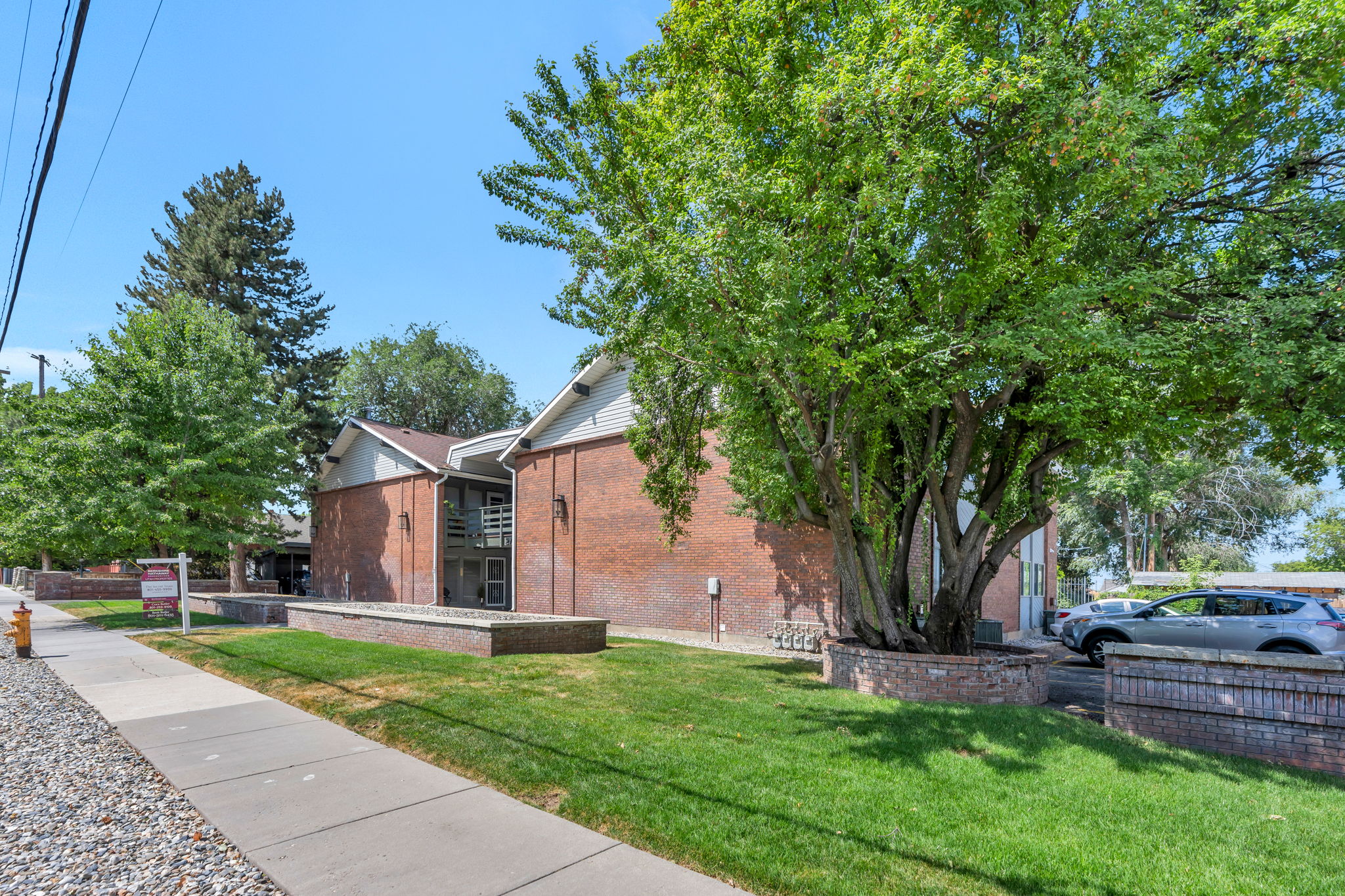 Brick facade building with gabled roof lines and exterior walkways