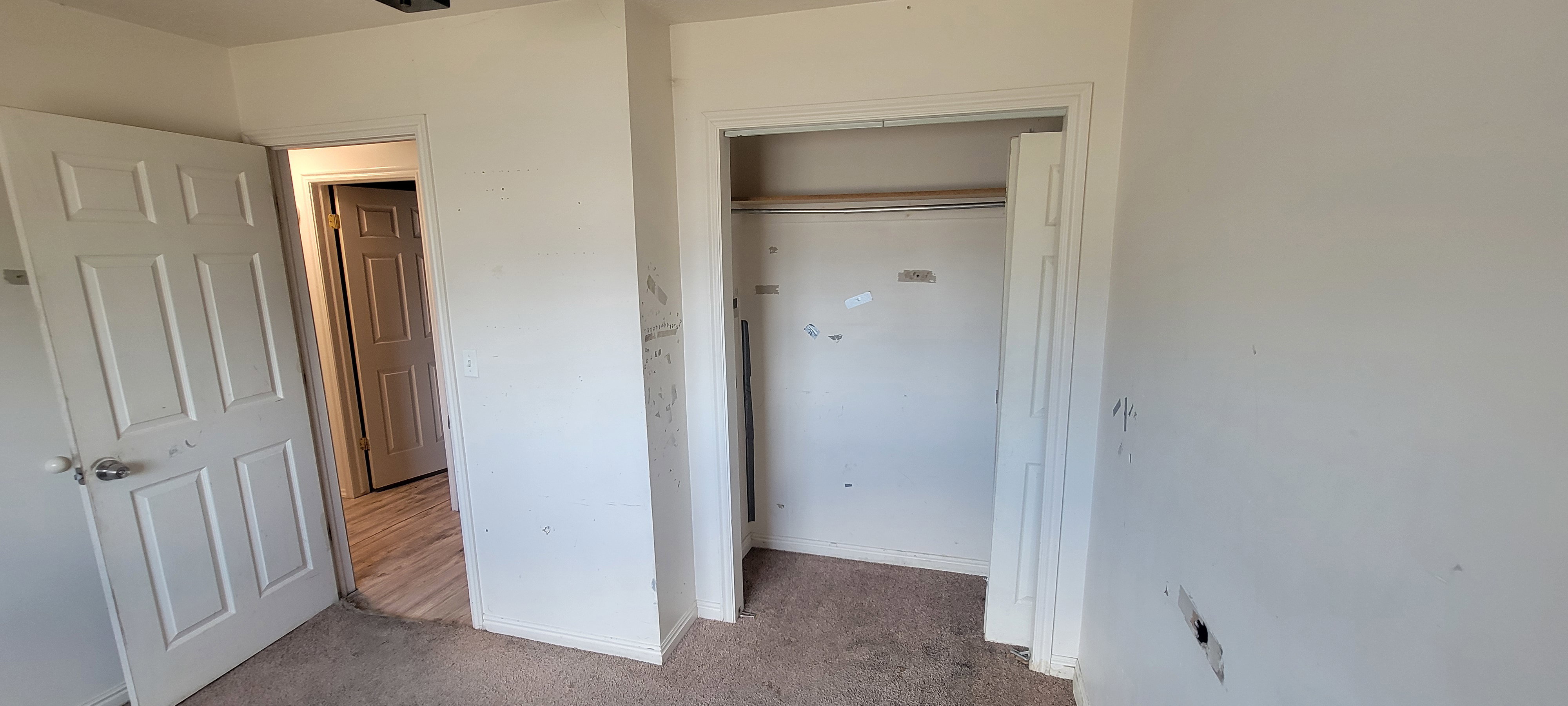 Neutral wall finishes with a built-in closet featuring an interior rod
