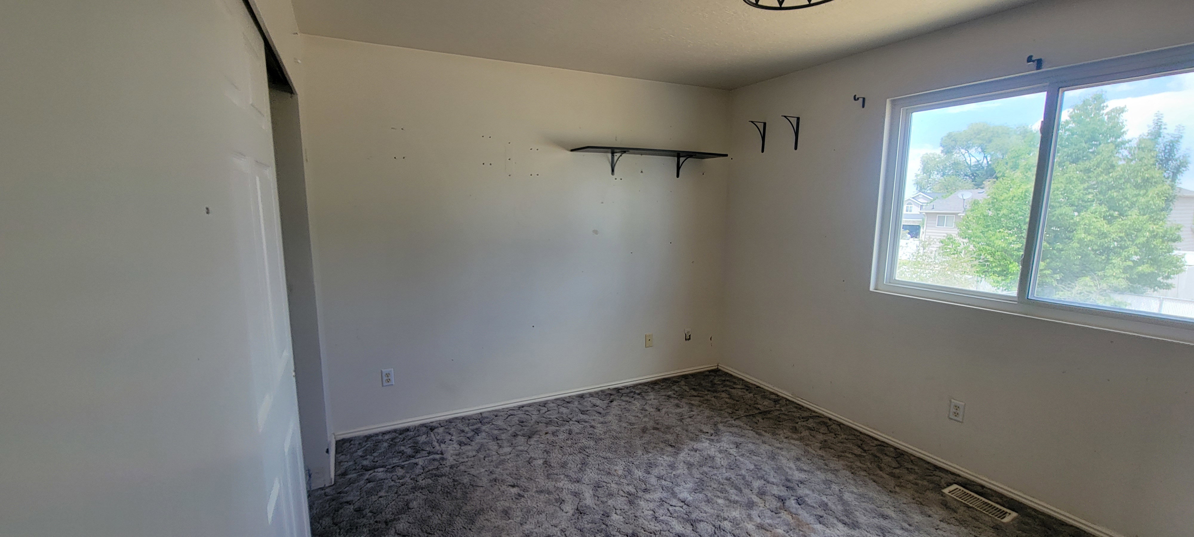 Room featuring light-colored walls and patterned carpeting