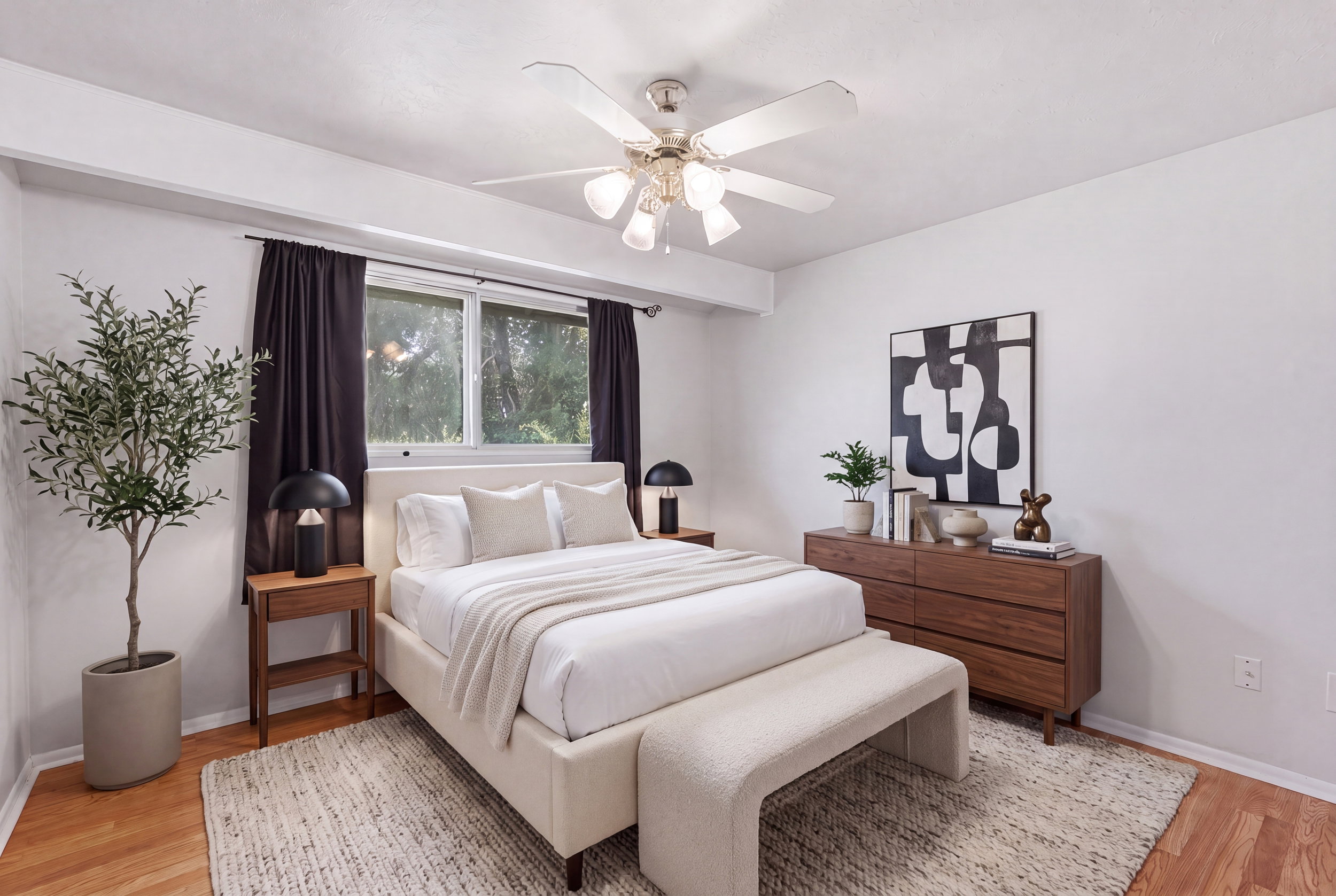 Bedroom featuring wood-finish flooring, a ceiling fan with integrated lighting, and a large window with dark drapery
