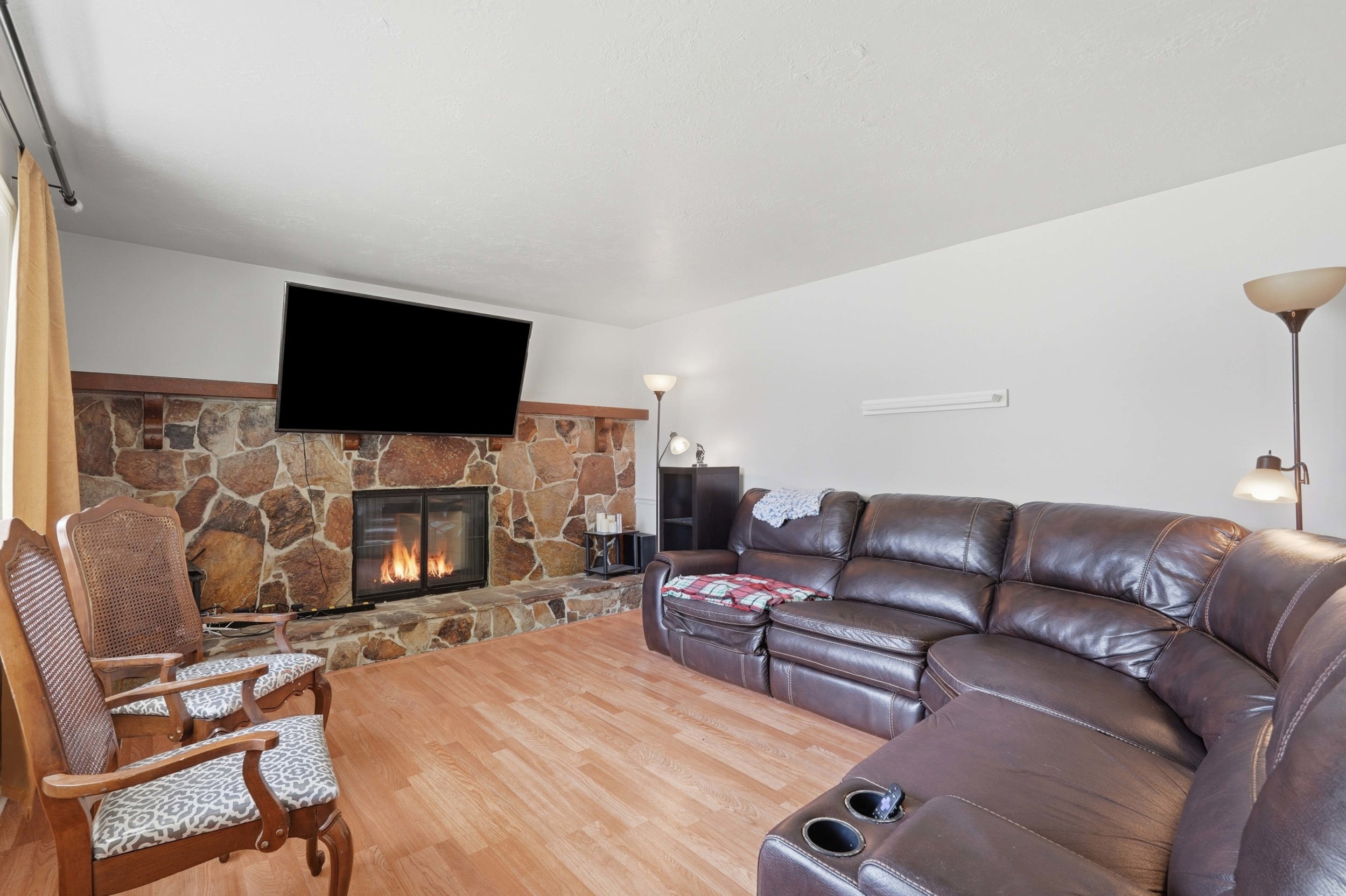 Stone-faced fireplace with a wood mantel