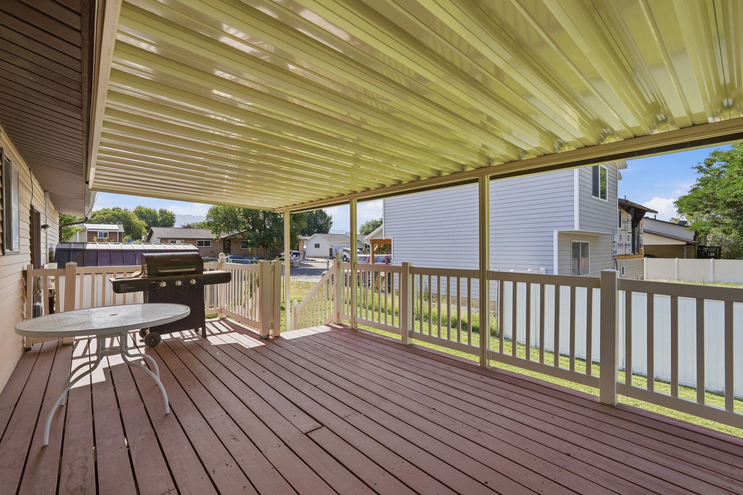 Covered wood deck with protective railing