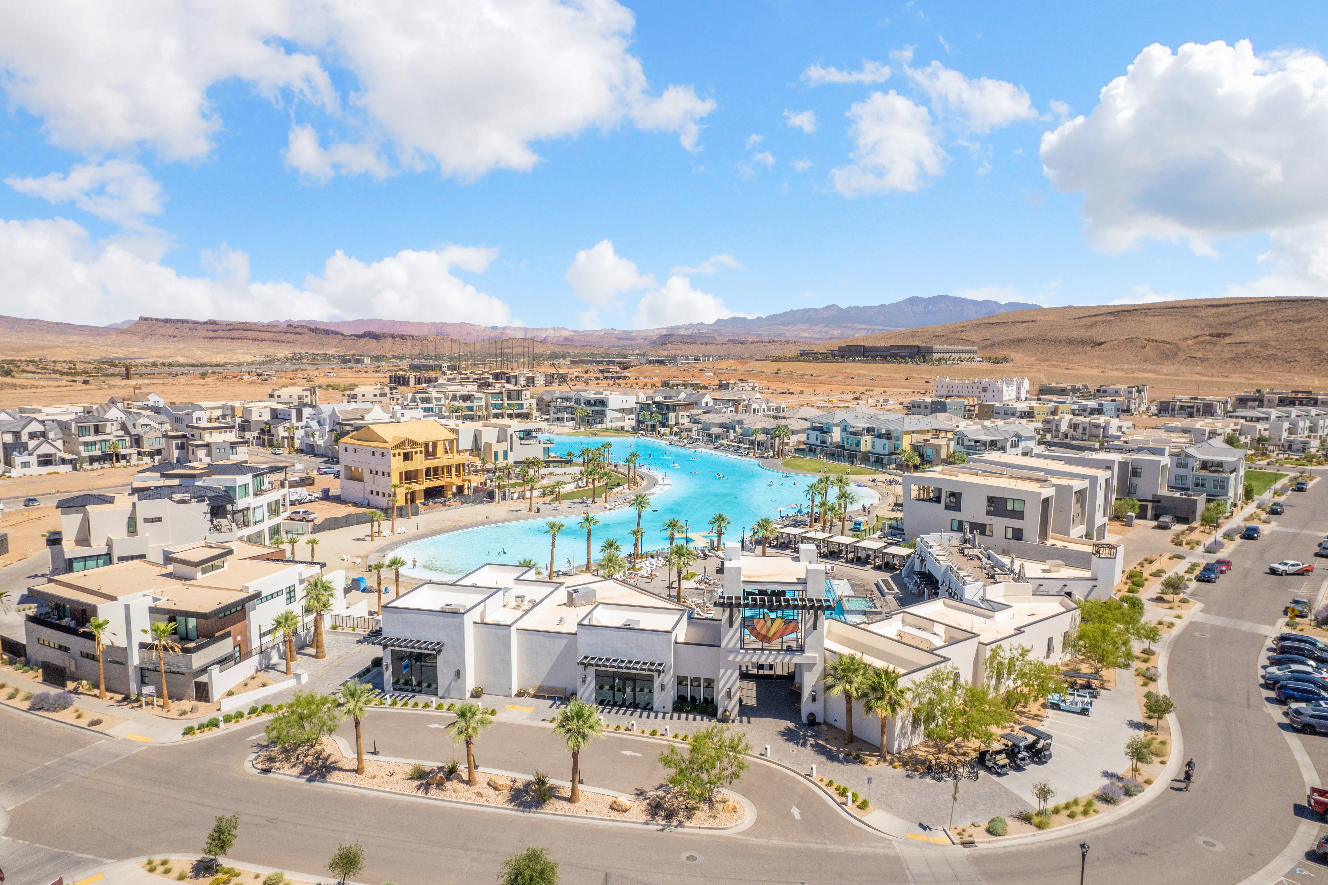 Expansive resort-style community featuring a large lagoon-style pool with surrounding residential structures and commercial buildings