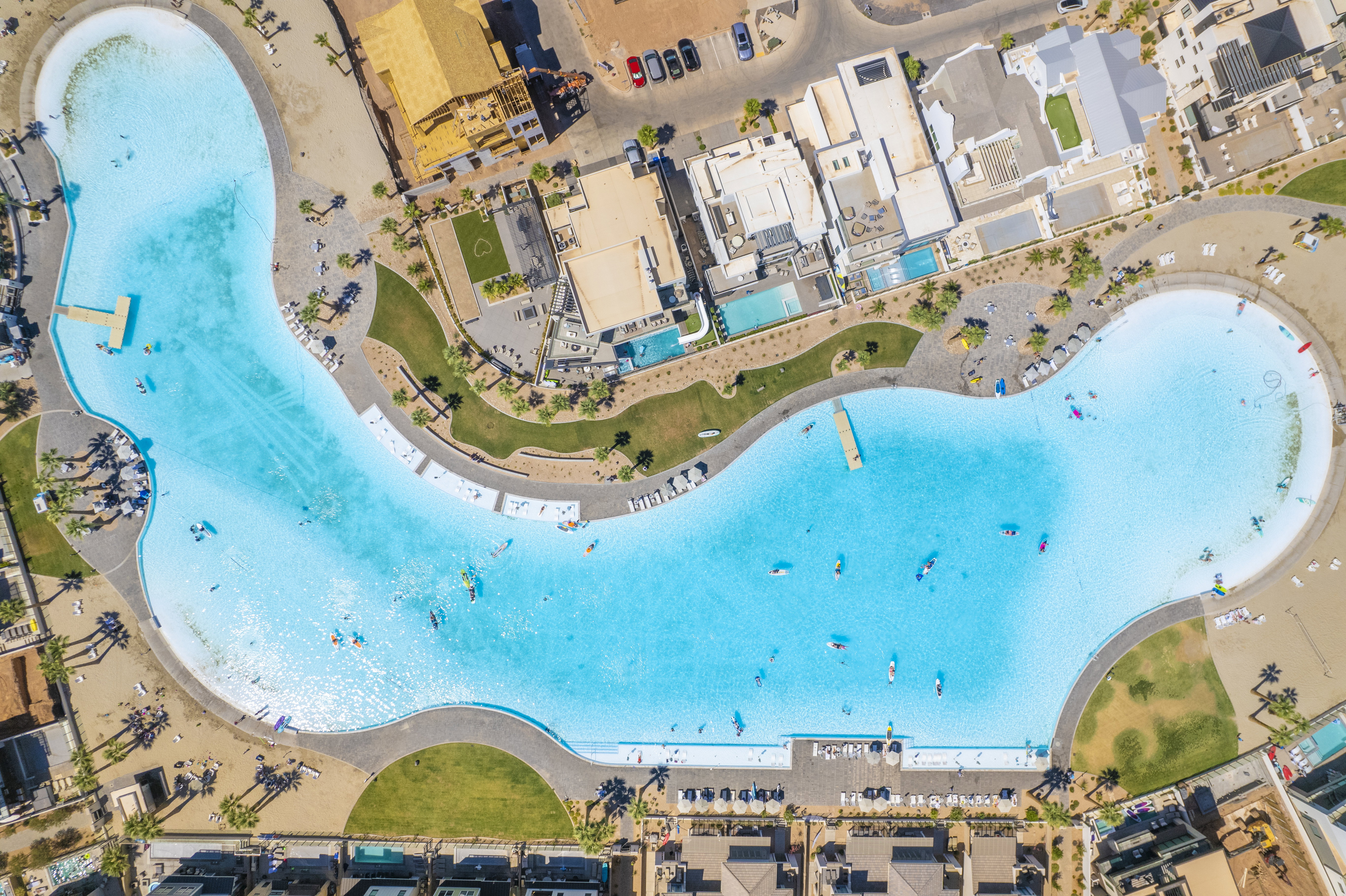 Expansive community lagoon featuring clear blue water and multiple docks