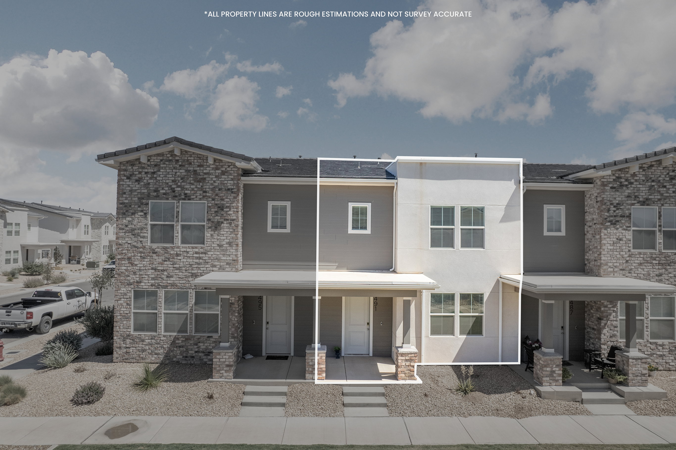 Two-story townhome featuring a stucco facade, covered front porch, and ground-level entryway