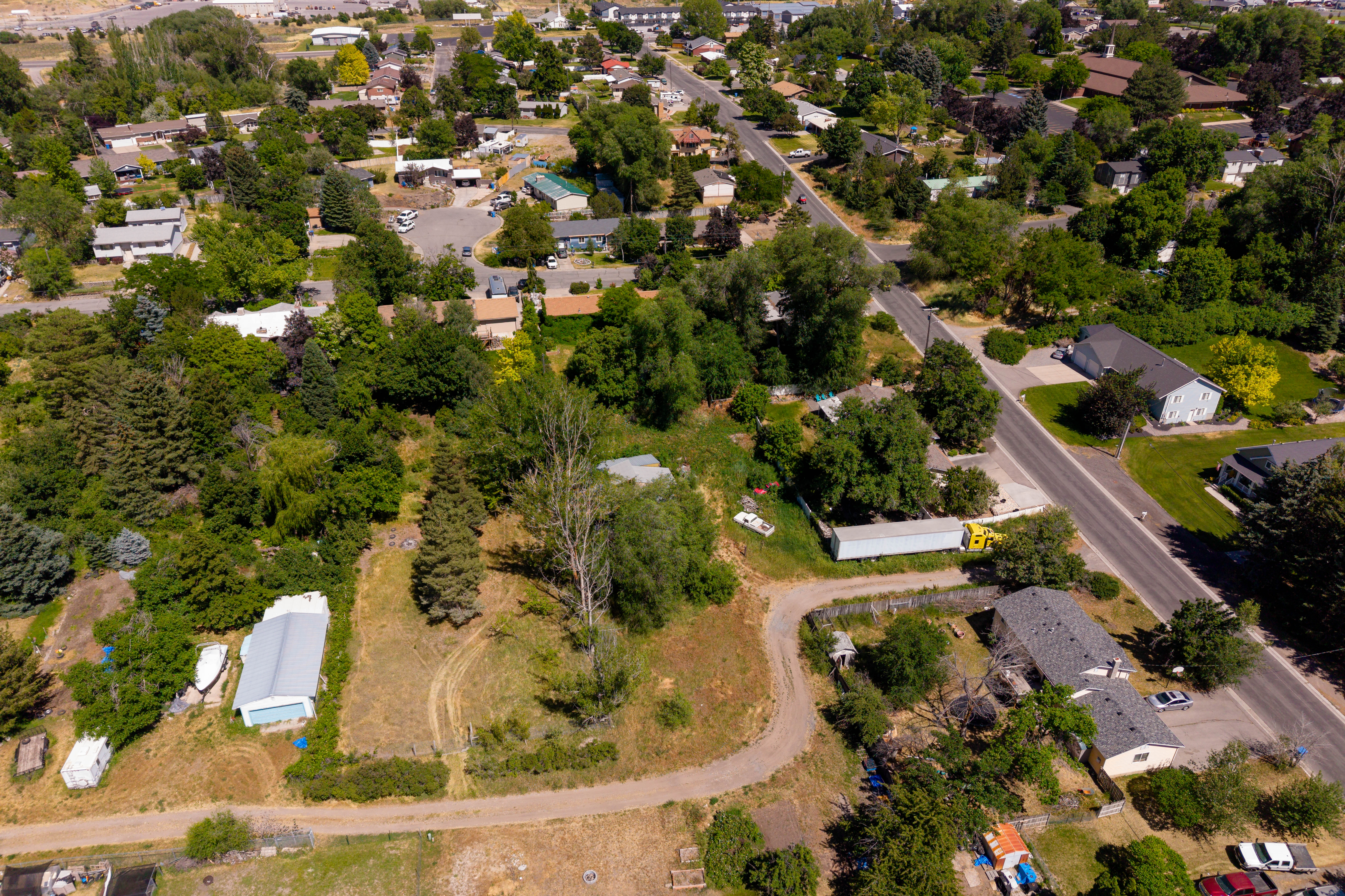 Expansive lot featuring mature trees and a detached structure