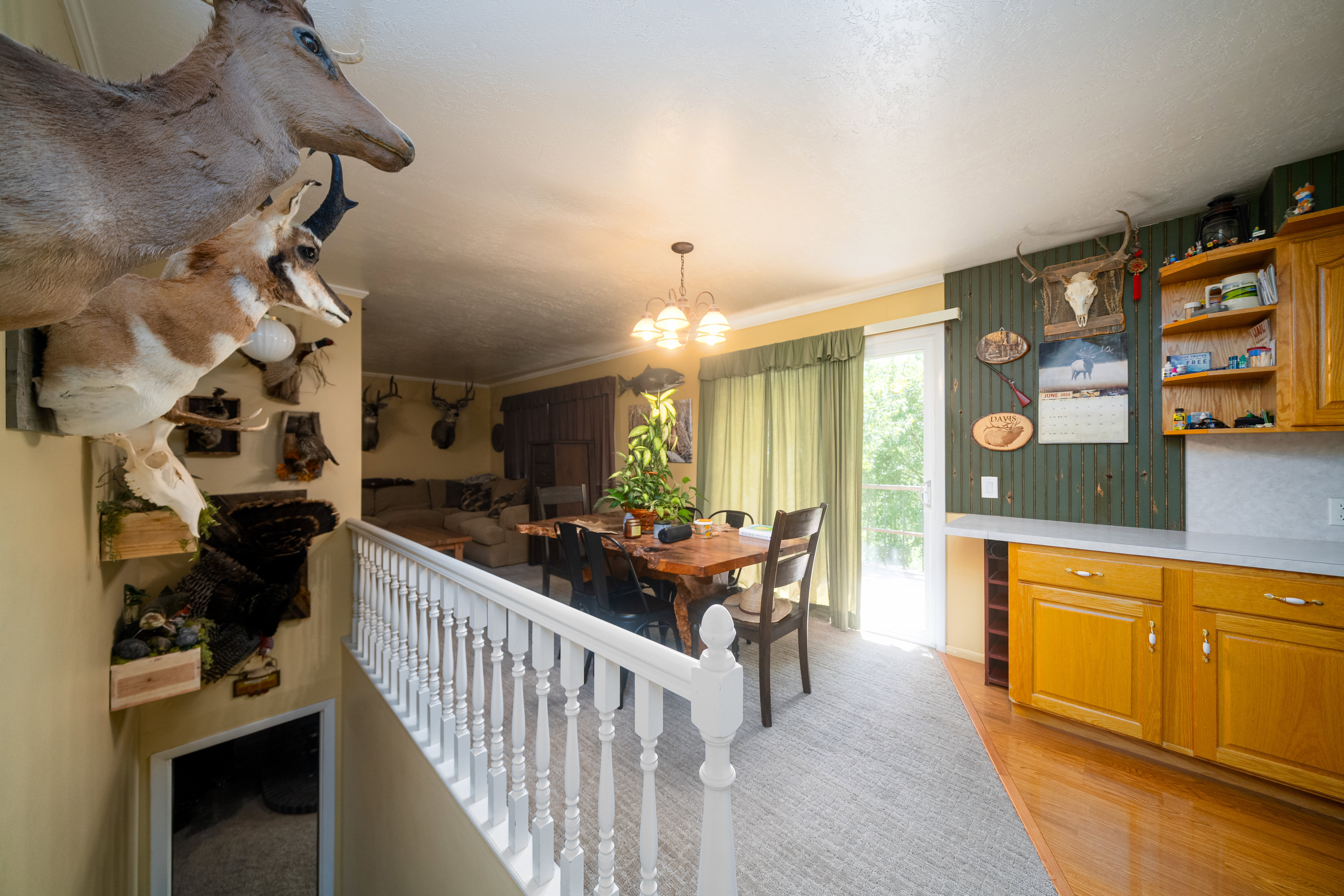 Dining area featuring wood-finish flooring, a sliding glass door, and a built-in kitchen counter with cabinetry