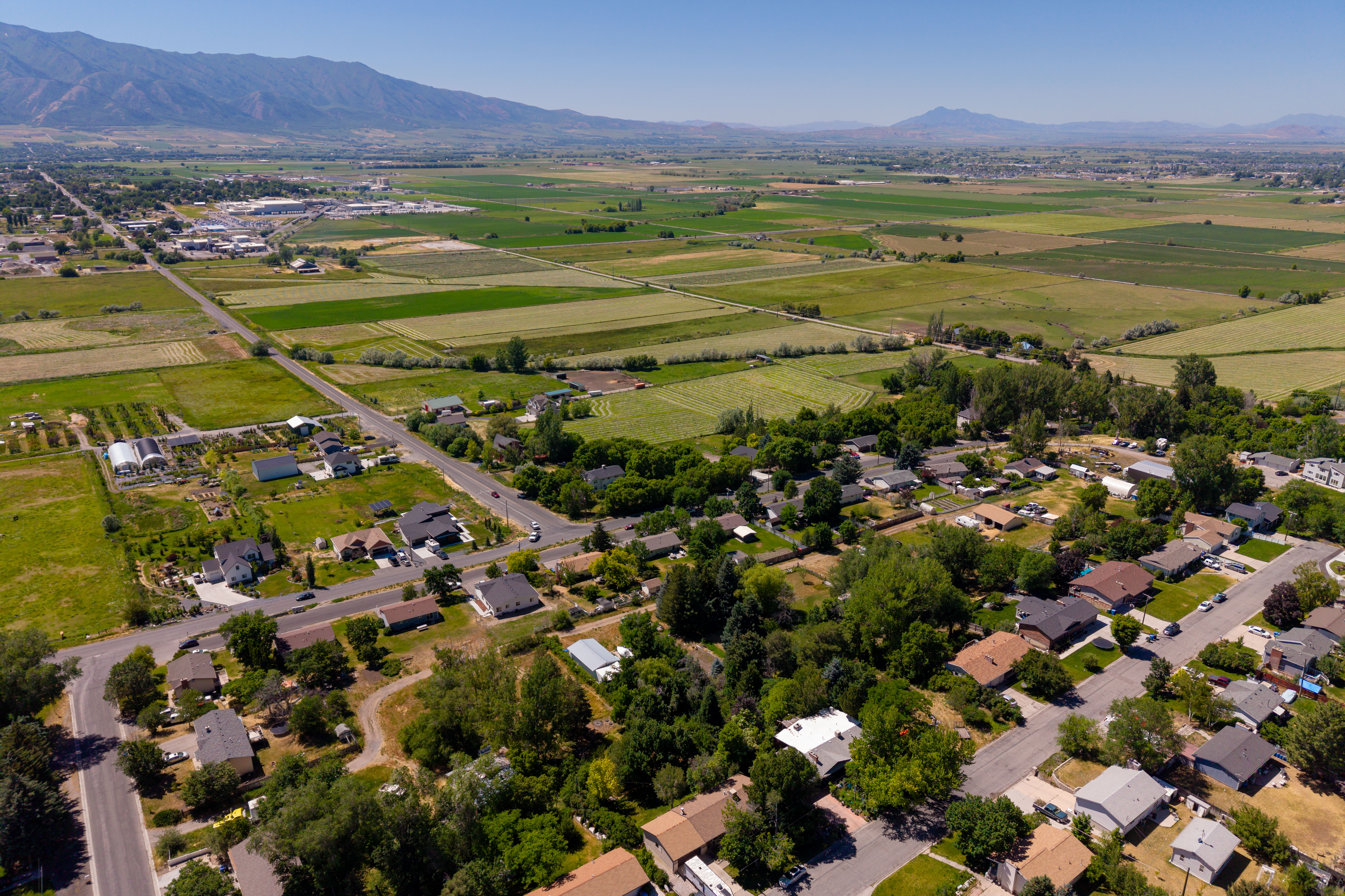 Aerial perspective showcasing residential areas bordered by extensive green agricultural fields