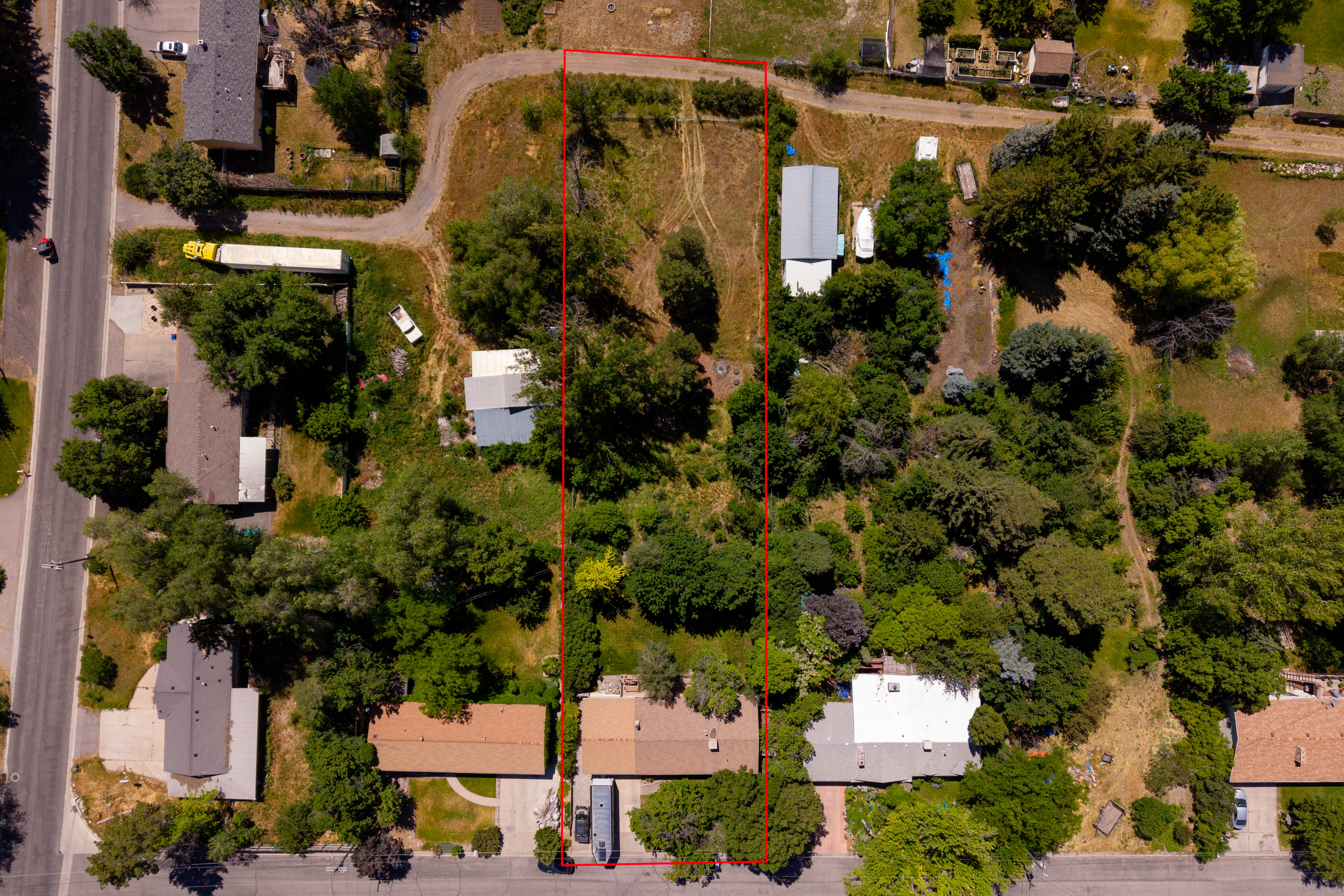 Expansive lot featuring mature trees and varied terrain