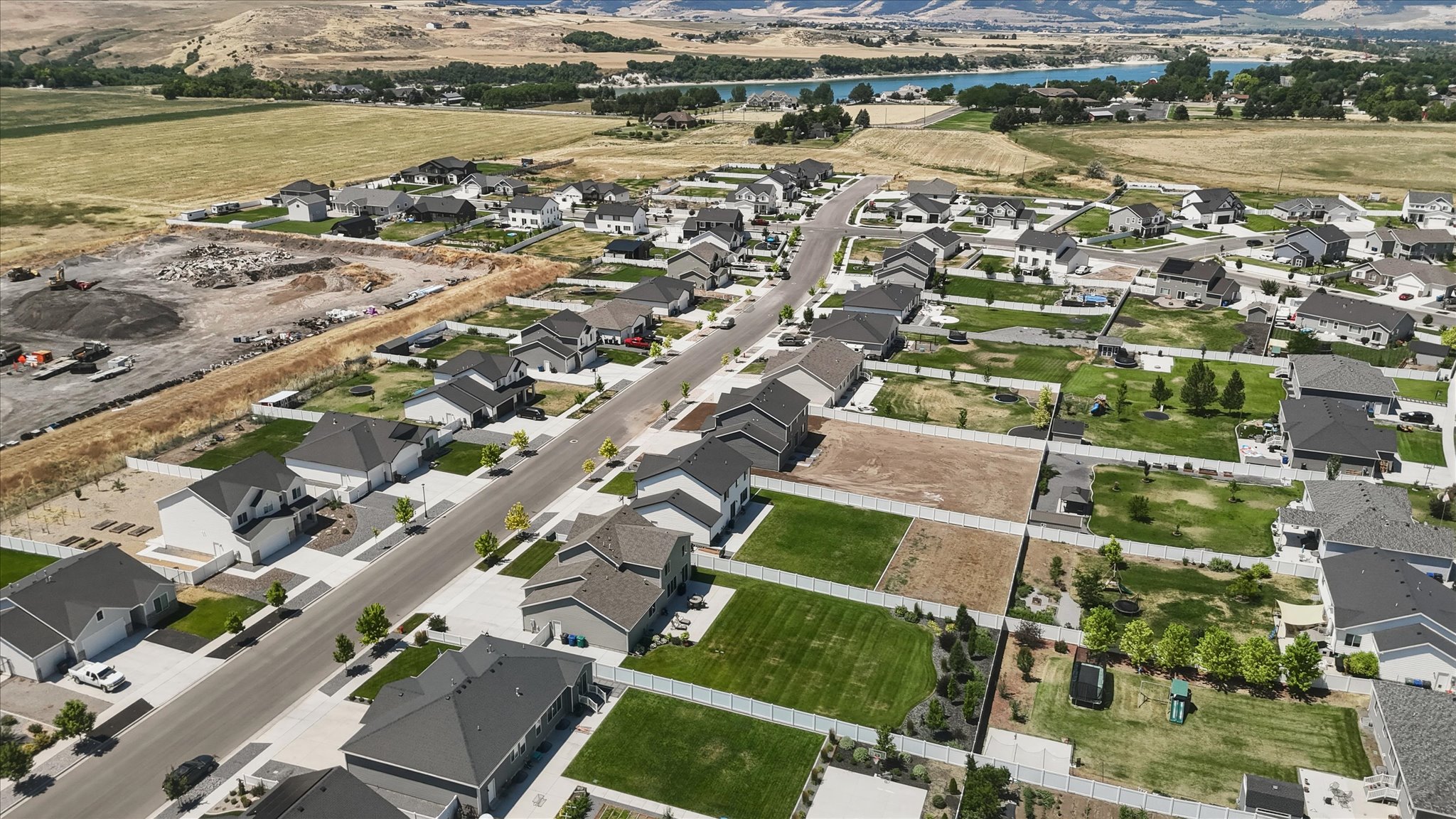 Contemporary suburban development featuring a mix of completed homes and buildable lots