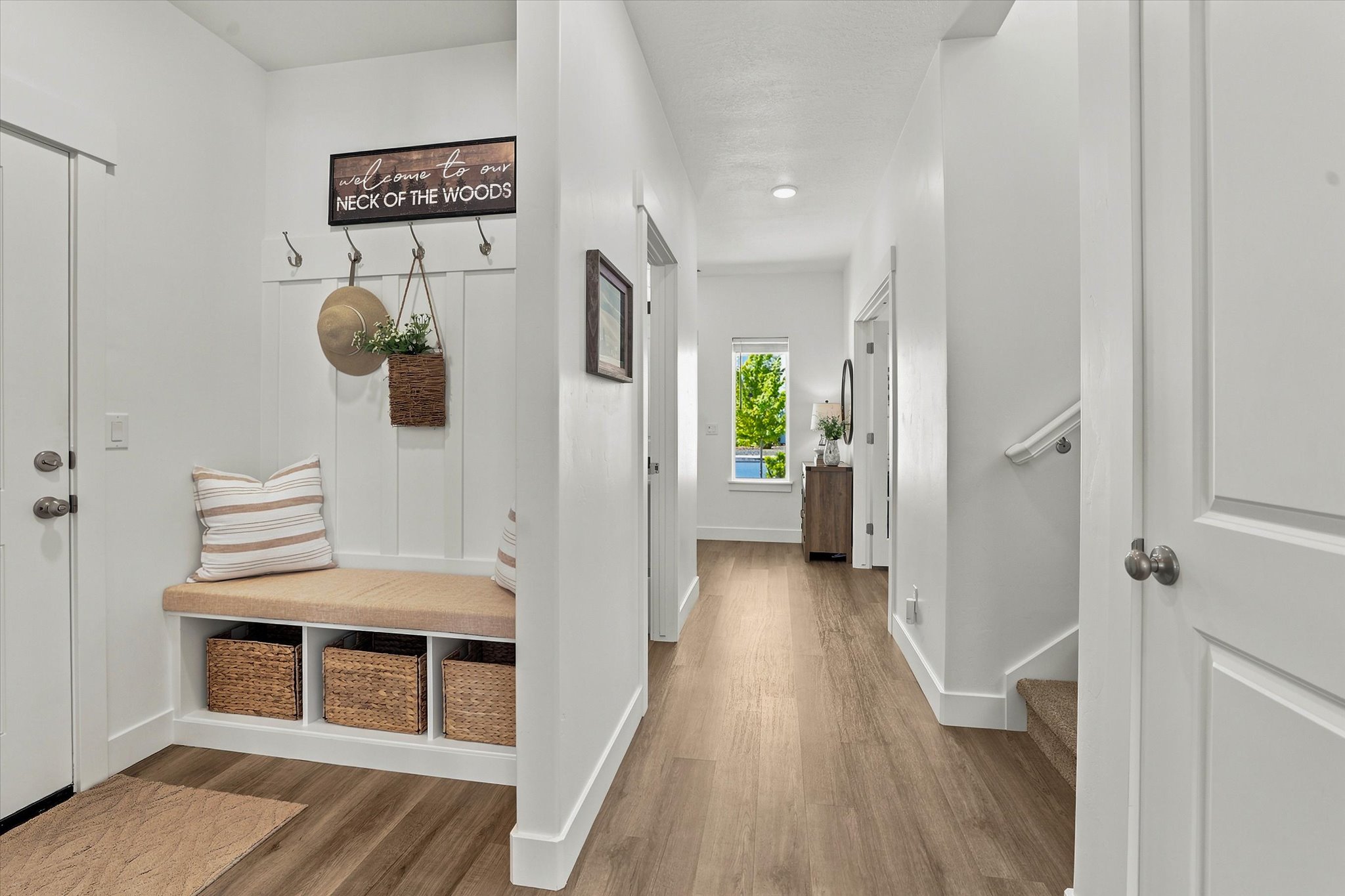 Entryway mudroom bench with integrated storage cubbies and wall-mounted coat hooks