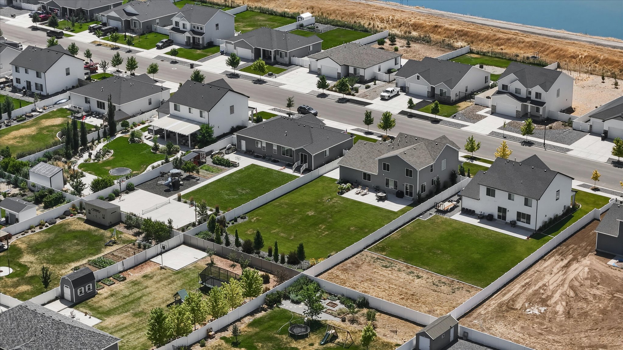 Aerial perspective of a developed residential area with a water body in the background