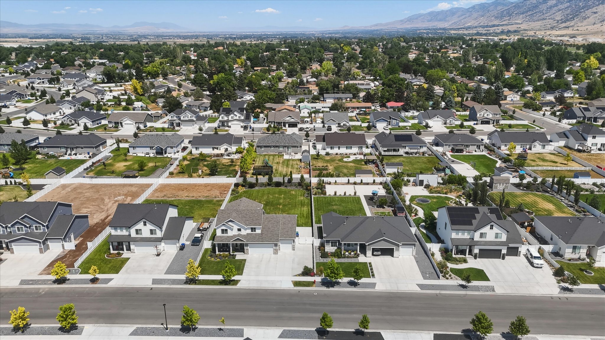 Expansive residential neighborhood featuring numerous single-family homes with dark roofs and light-colored exteriors