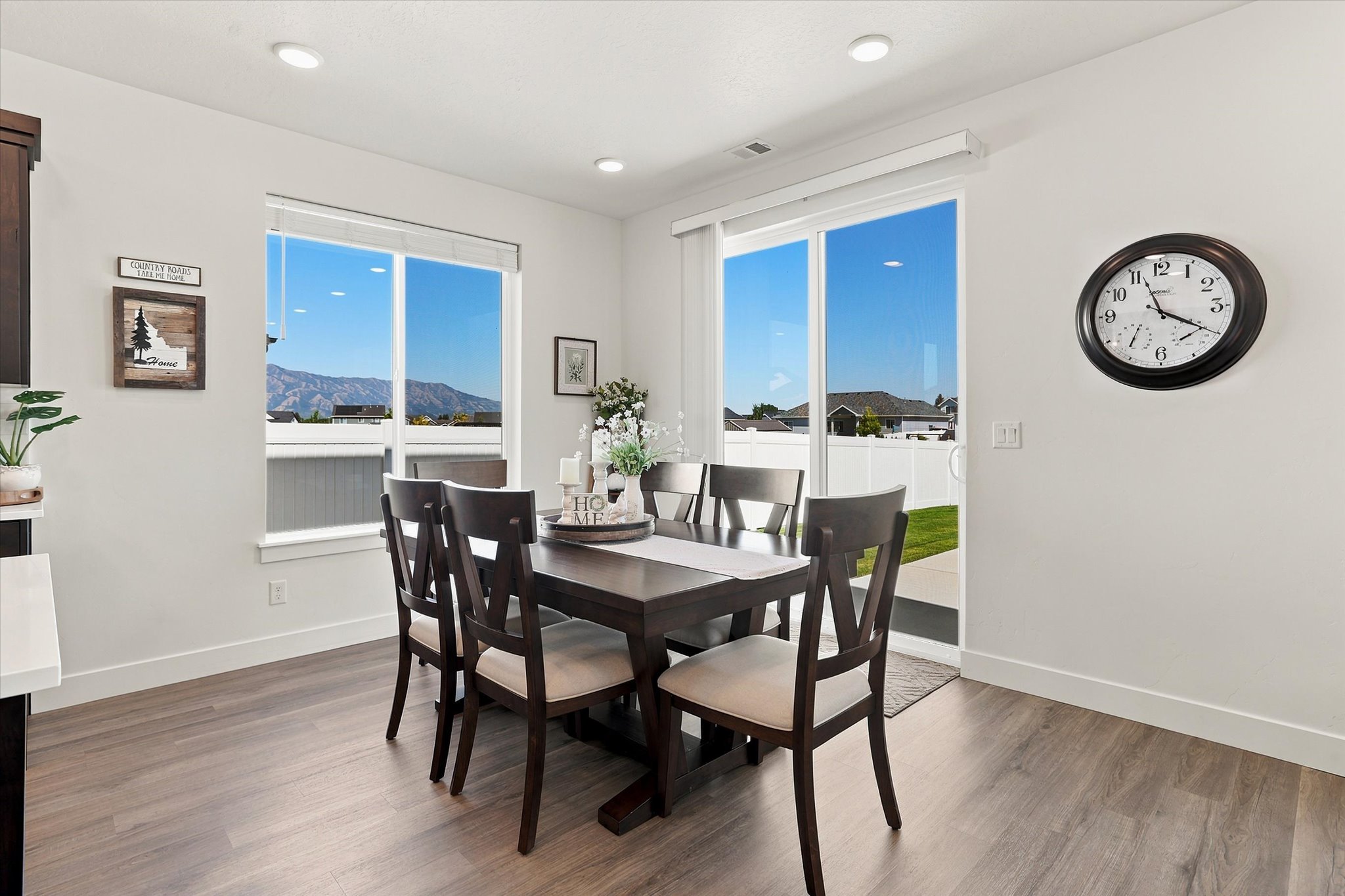 Dining area featuring wood-finish flooring, recessed lighting, and a sliding glass door to a grassy exterior