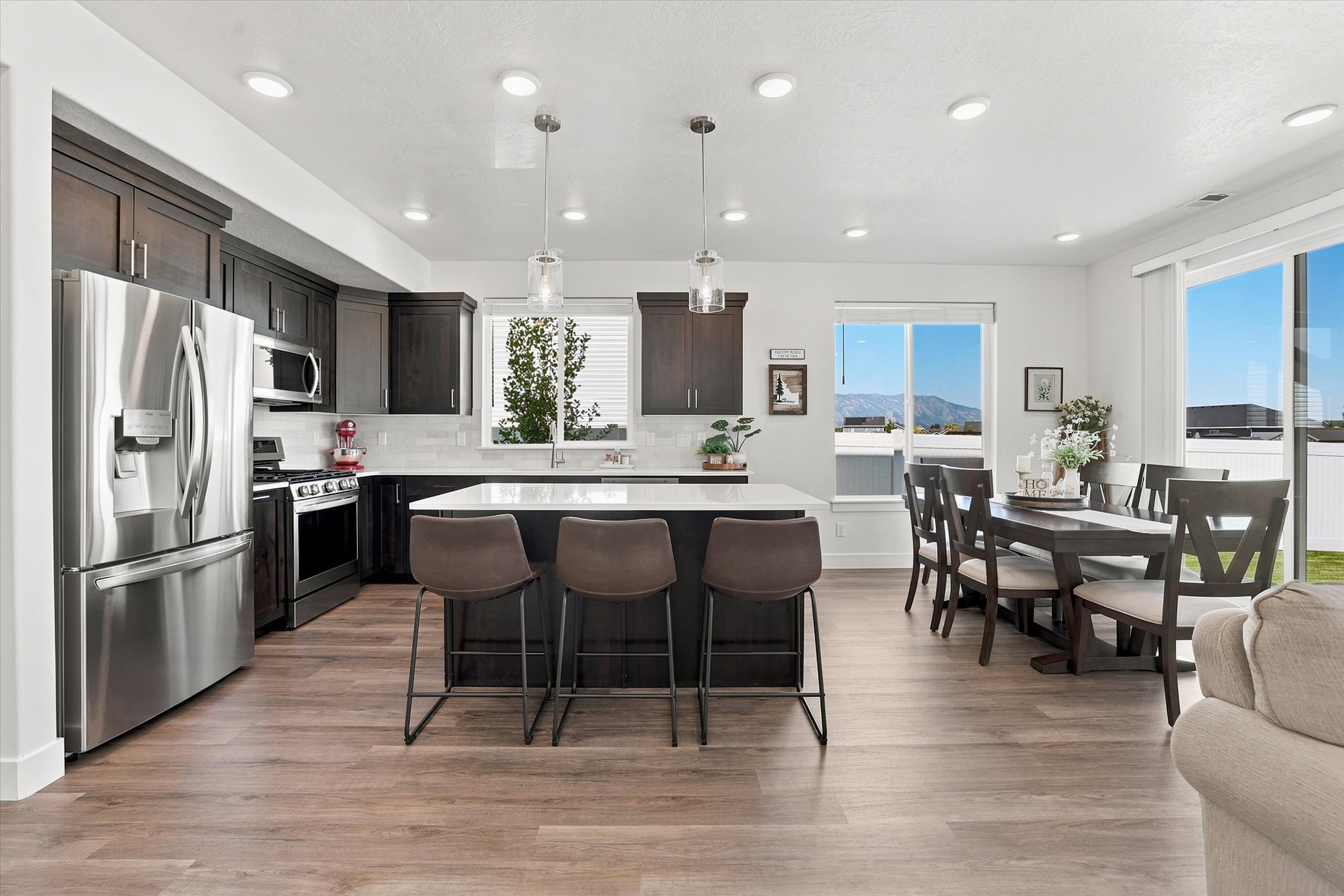 Open-concept kitchen and dining area with wood-finish flooring