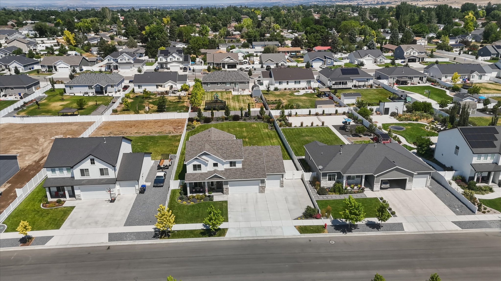 Aerial perspective showcasing a residential neighborhood with a mix of established homes and undeveloped lots