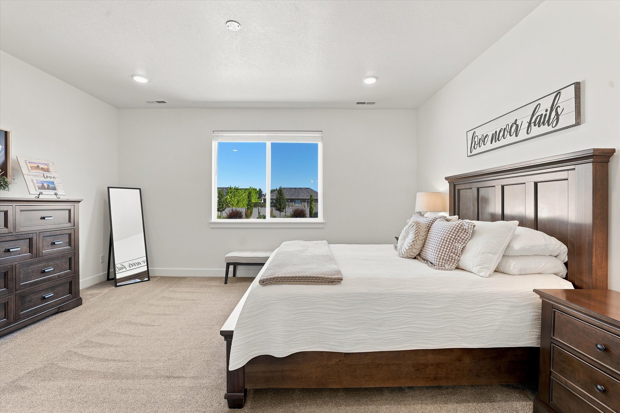 Bright interior featuring a double window, recessed lighting, and neutral carpet flooring