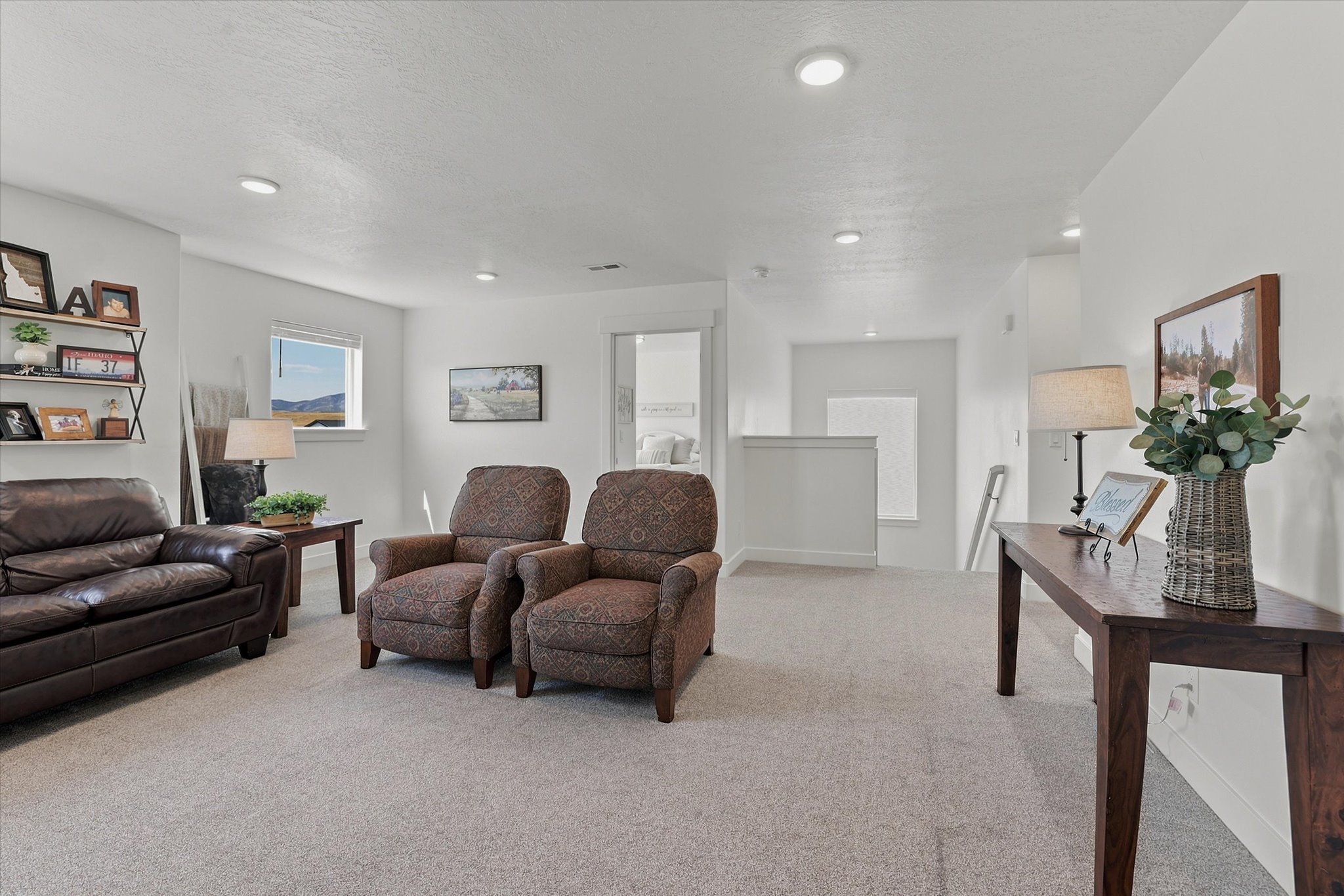 Open concept living space featuring neutral carpet flooring and recessed lighting