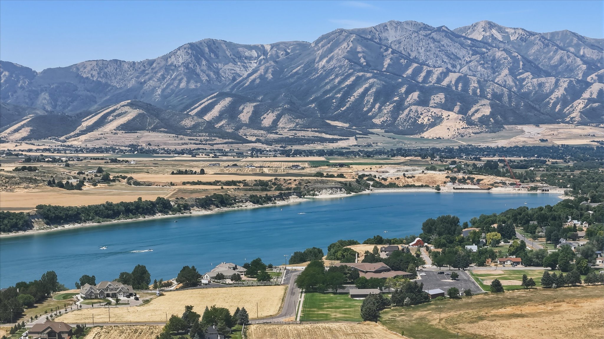 Expansive mountain range backdrop and a large body of water