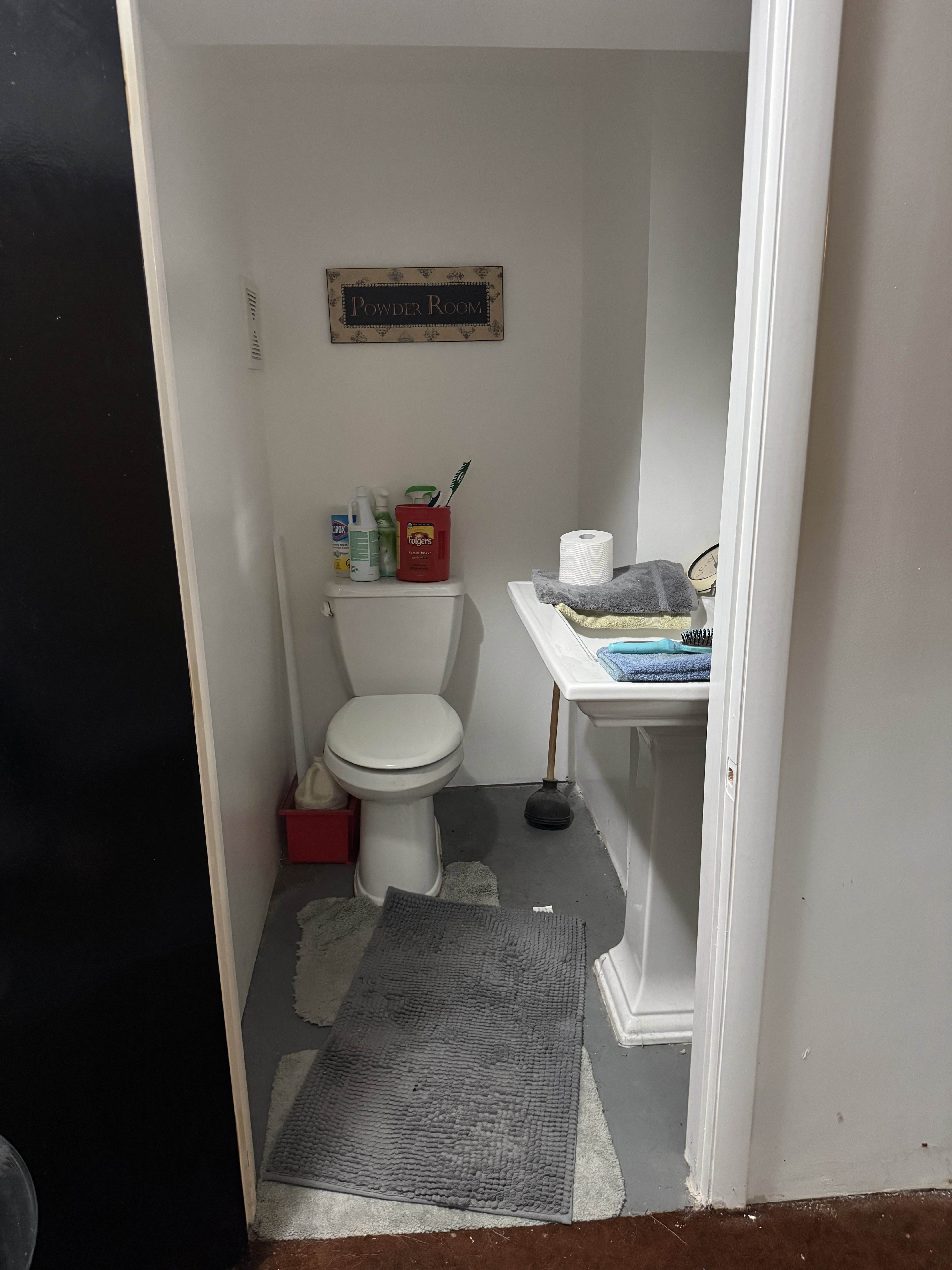 White pedestal sink with a matching commode
