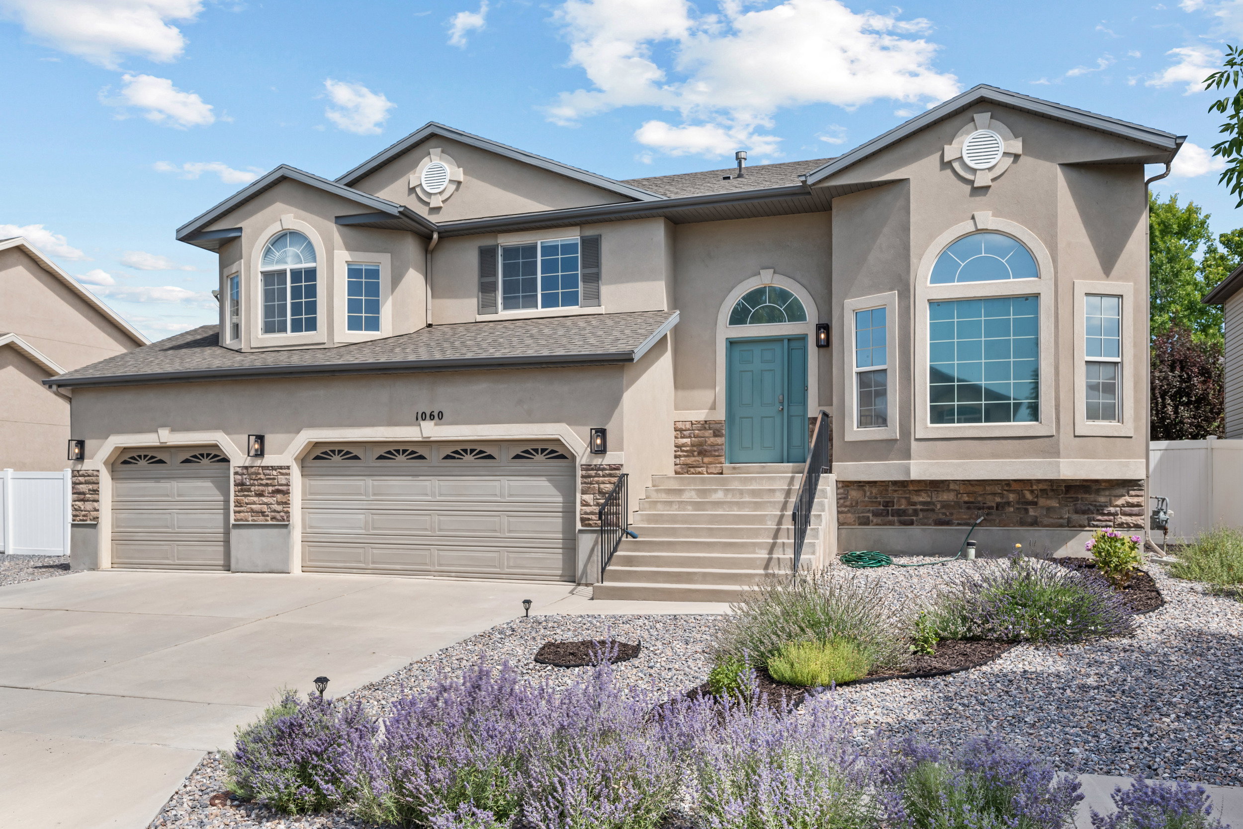 Stucco exterior with stone accents and arched windows