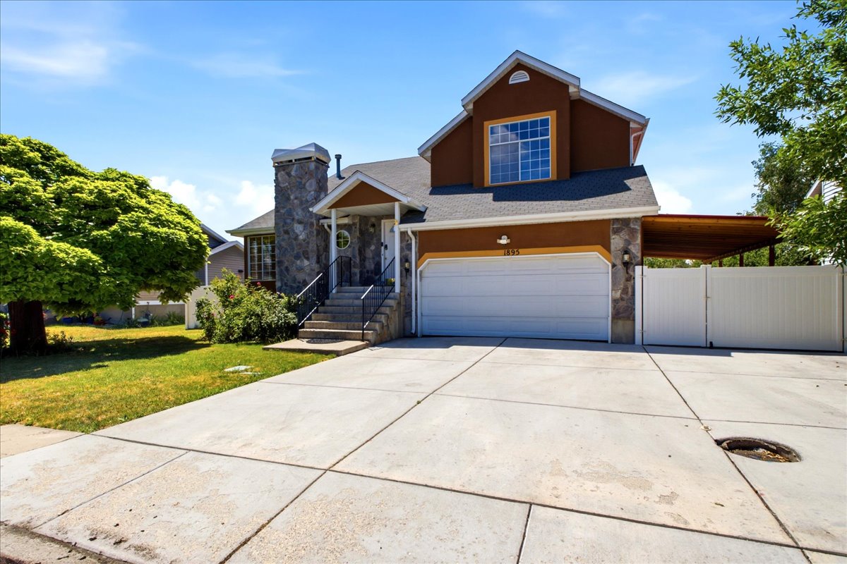 Stucco and stone facade with an attached two-car garage