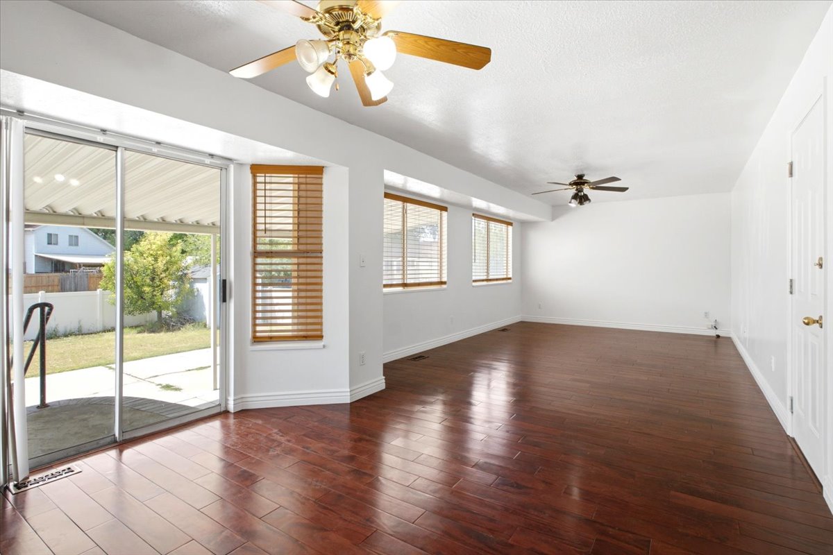 Open-concept living area with dark wood-finish flooring