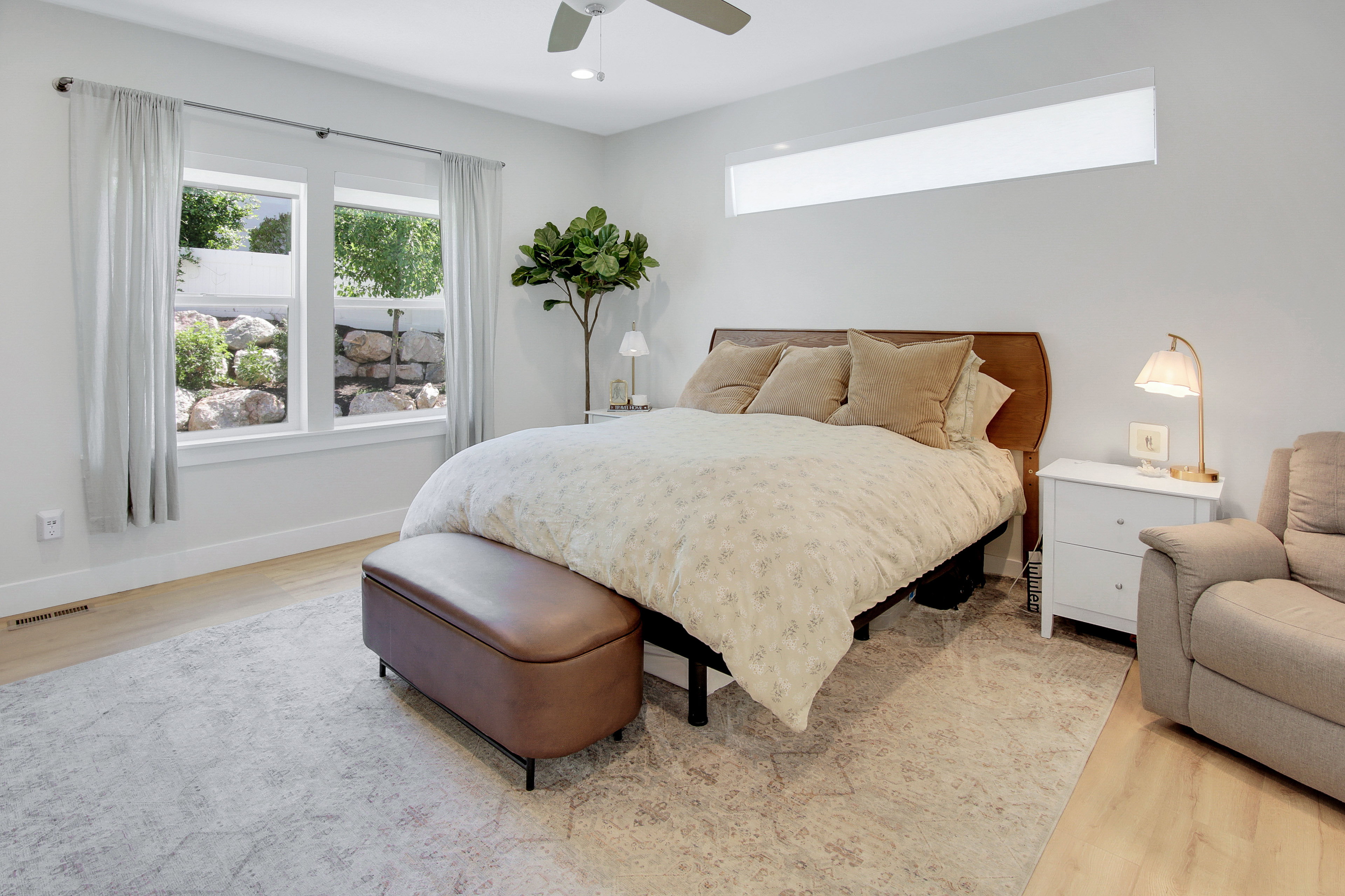 Spacious room featuring wood-finish flooring, a contemporary ceiling fan, and recessed lighting
