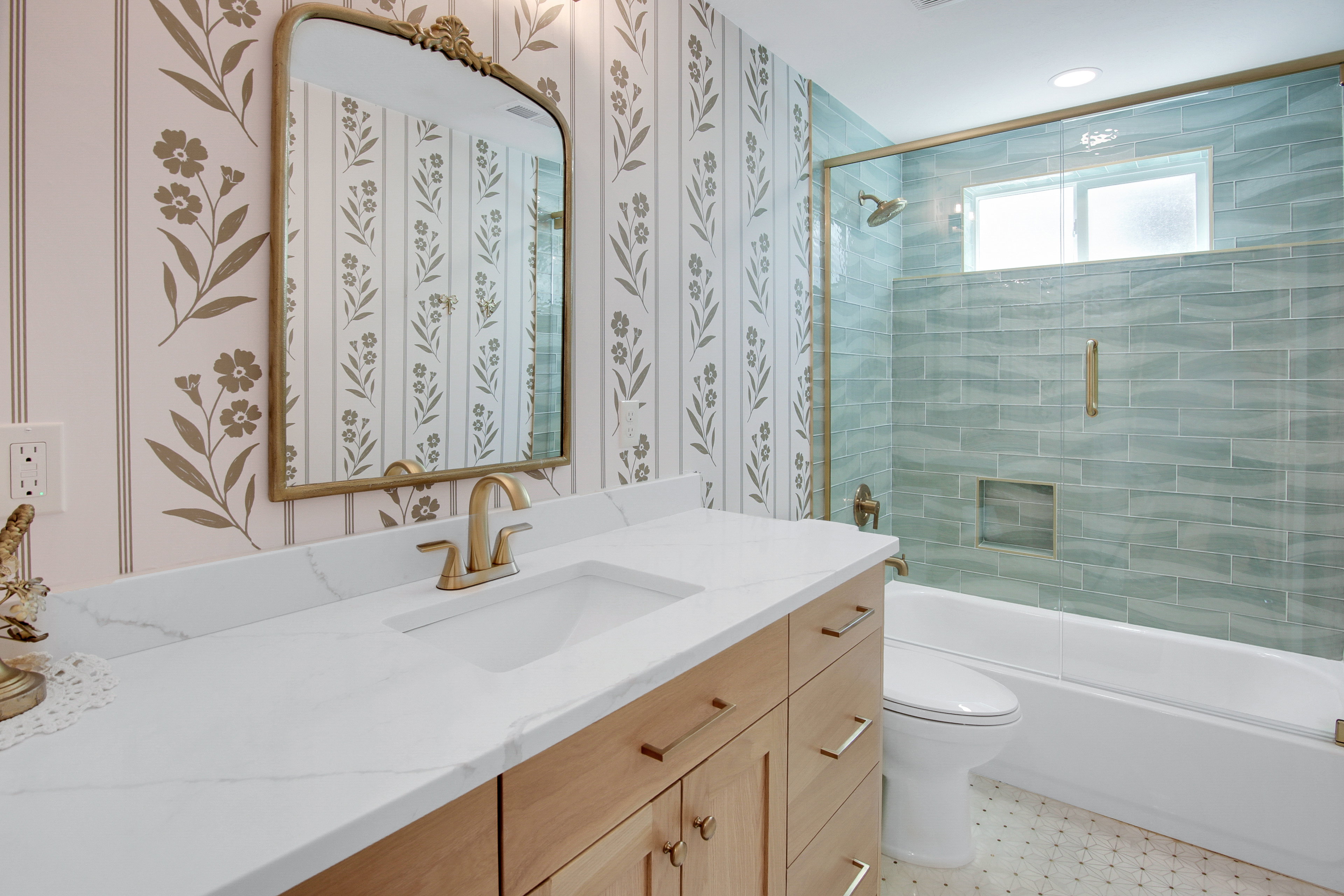 Bathroom featuring a light wood-finish vanity with a white countertop and integrated sink