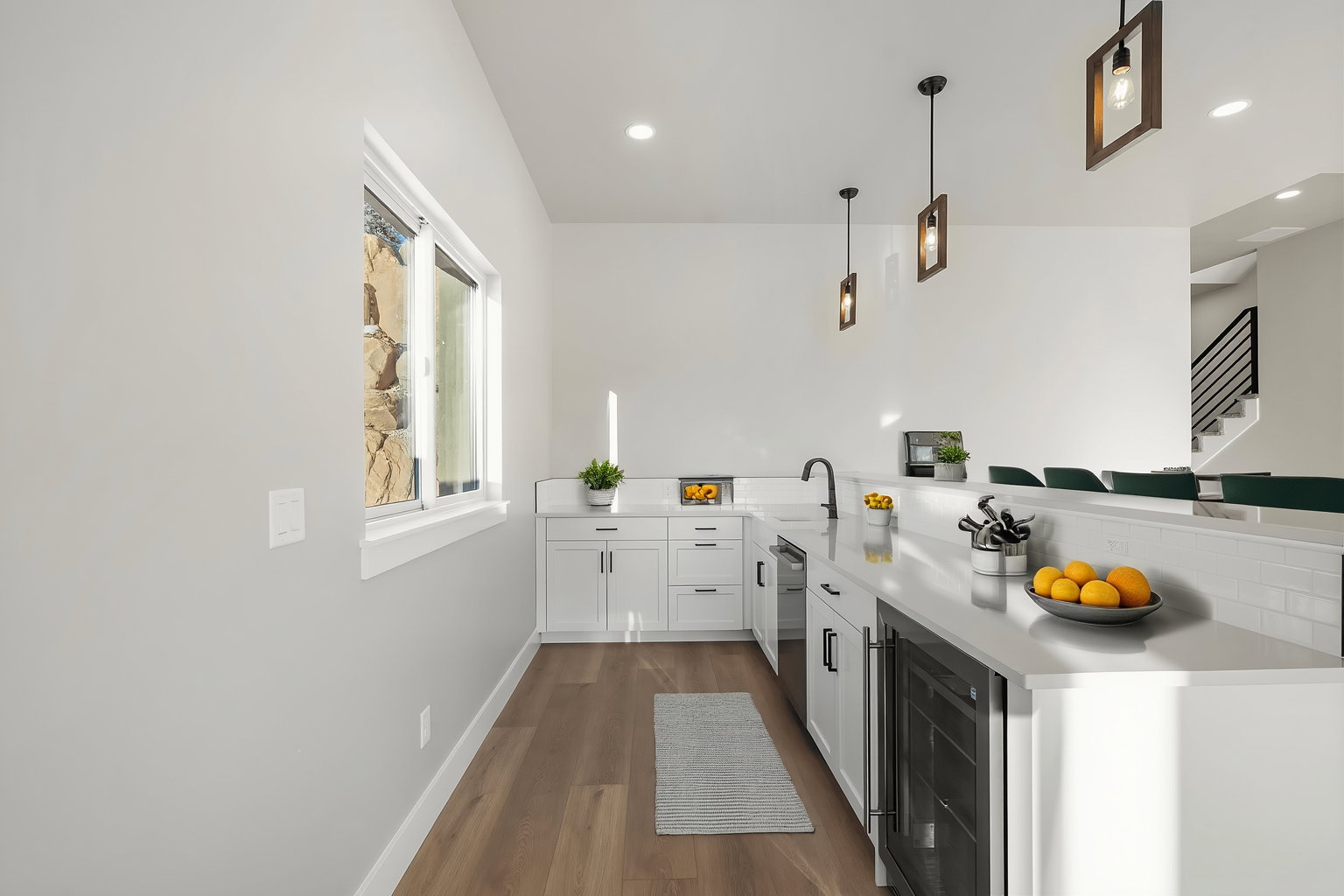 Modern kitchen with white cabinetry and light countertops
