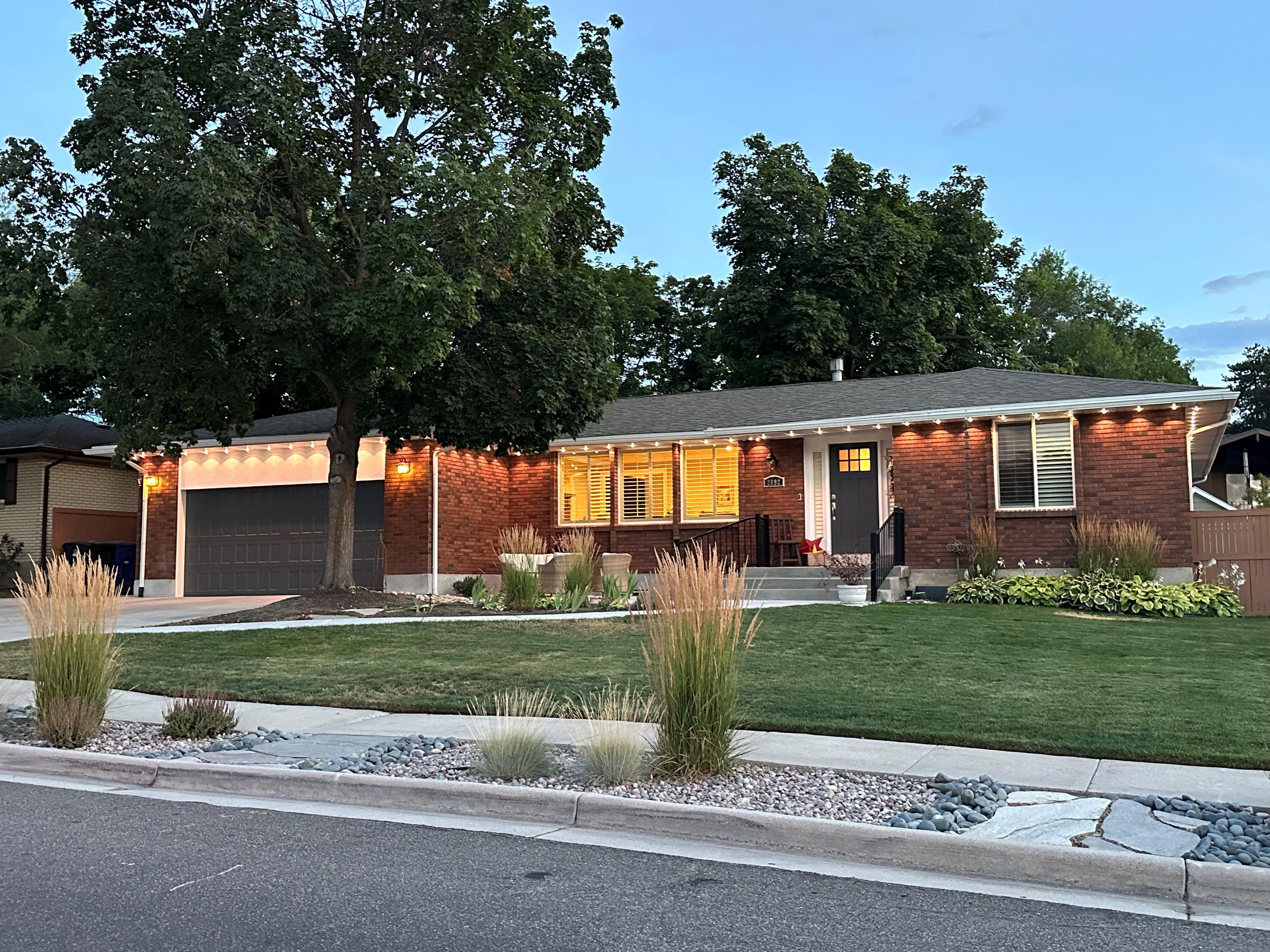 Brick facade with a dark gray front door and matching garage door