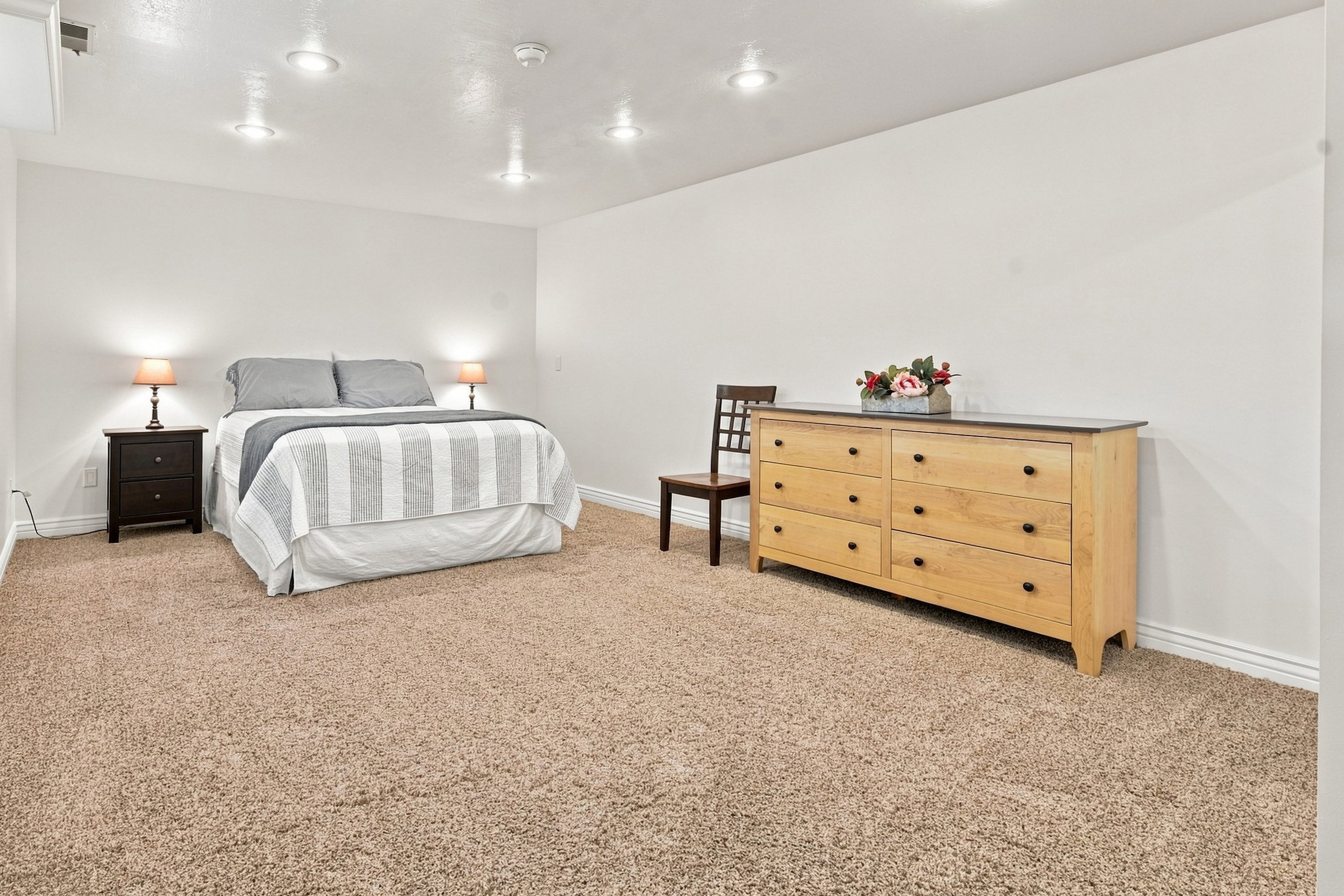 Carpeted room with recessed lighting and neutral wall tones
