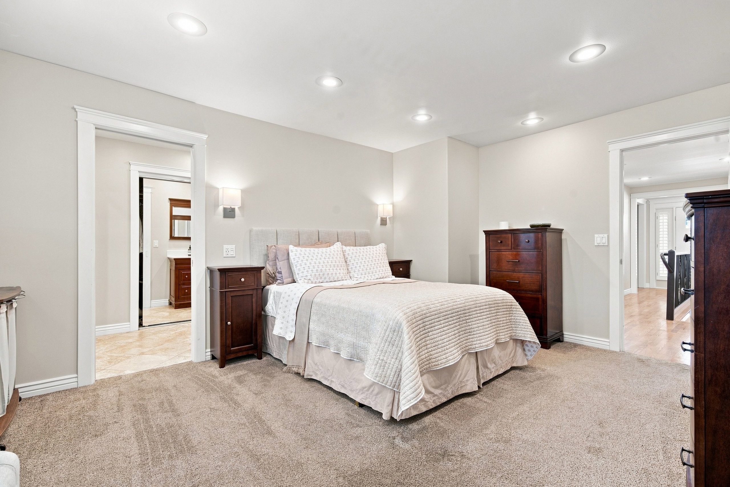 Carpeted Master bedroom featuring recessed lighting and wall sconces