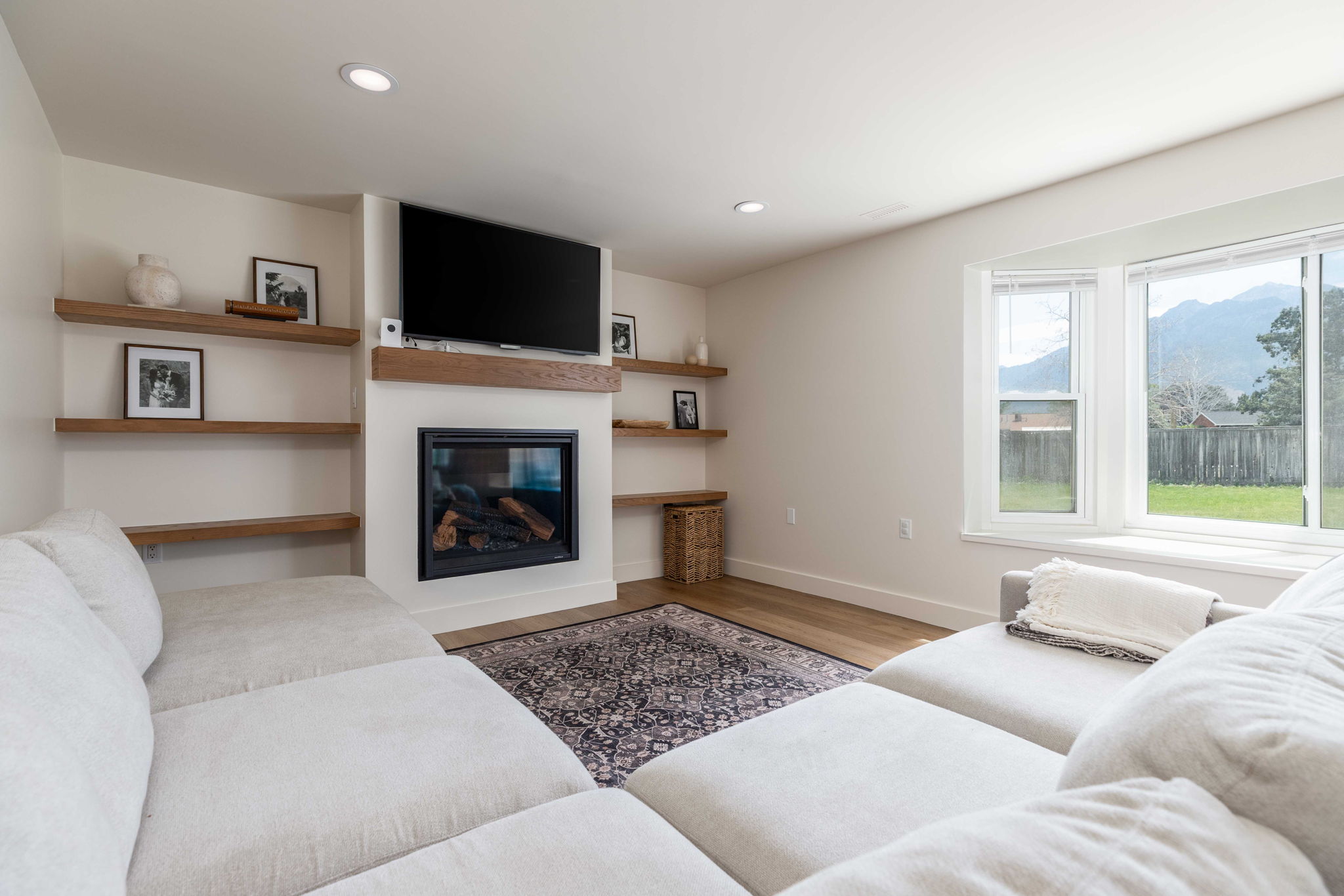 Living area with a built-in fireplace, mantle, and recessed lighting