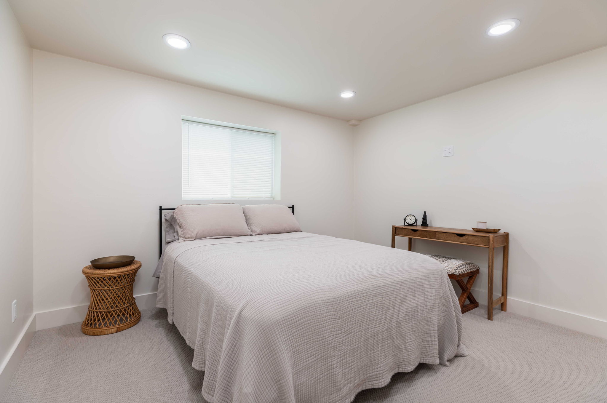 Carpeted room featuring recessed lighting, a window with a roller shade, and white baseboards