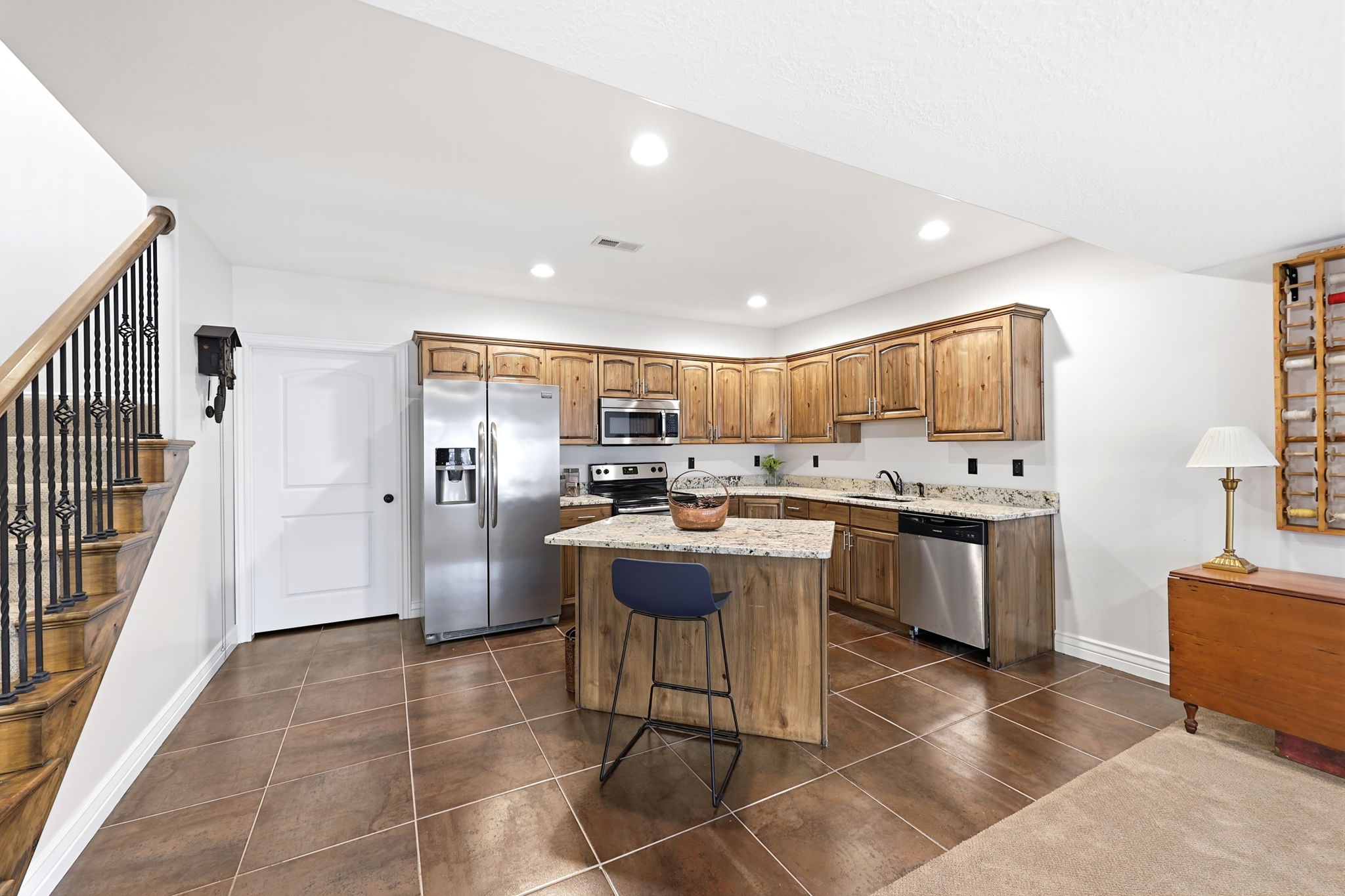 Kitchen with wood-finish cabinetry, granite countertops, and stainless steel appliances