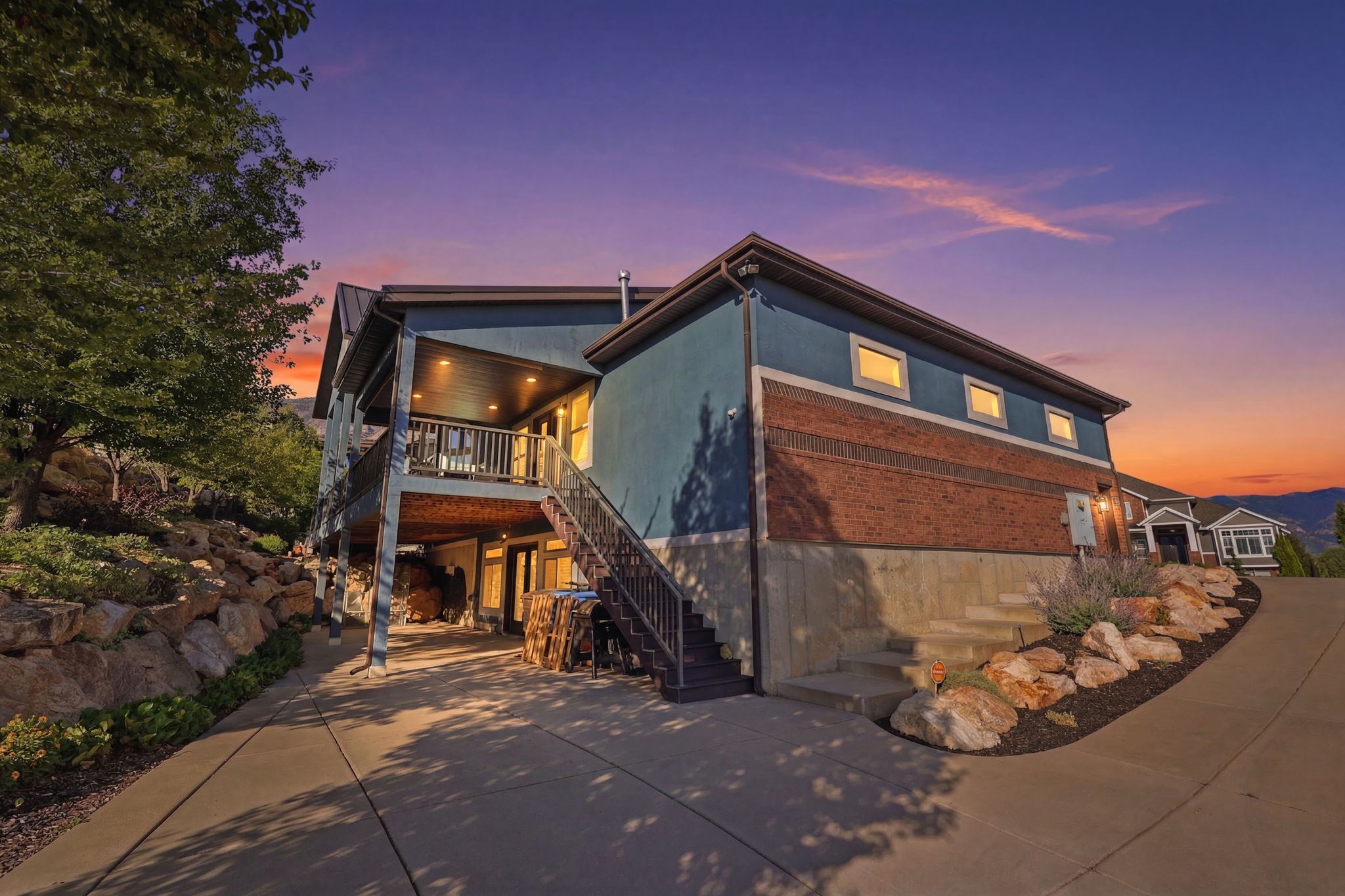 Multi-level residence featuring a brick and stucco exterior
