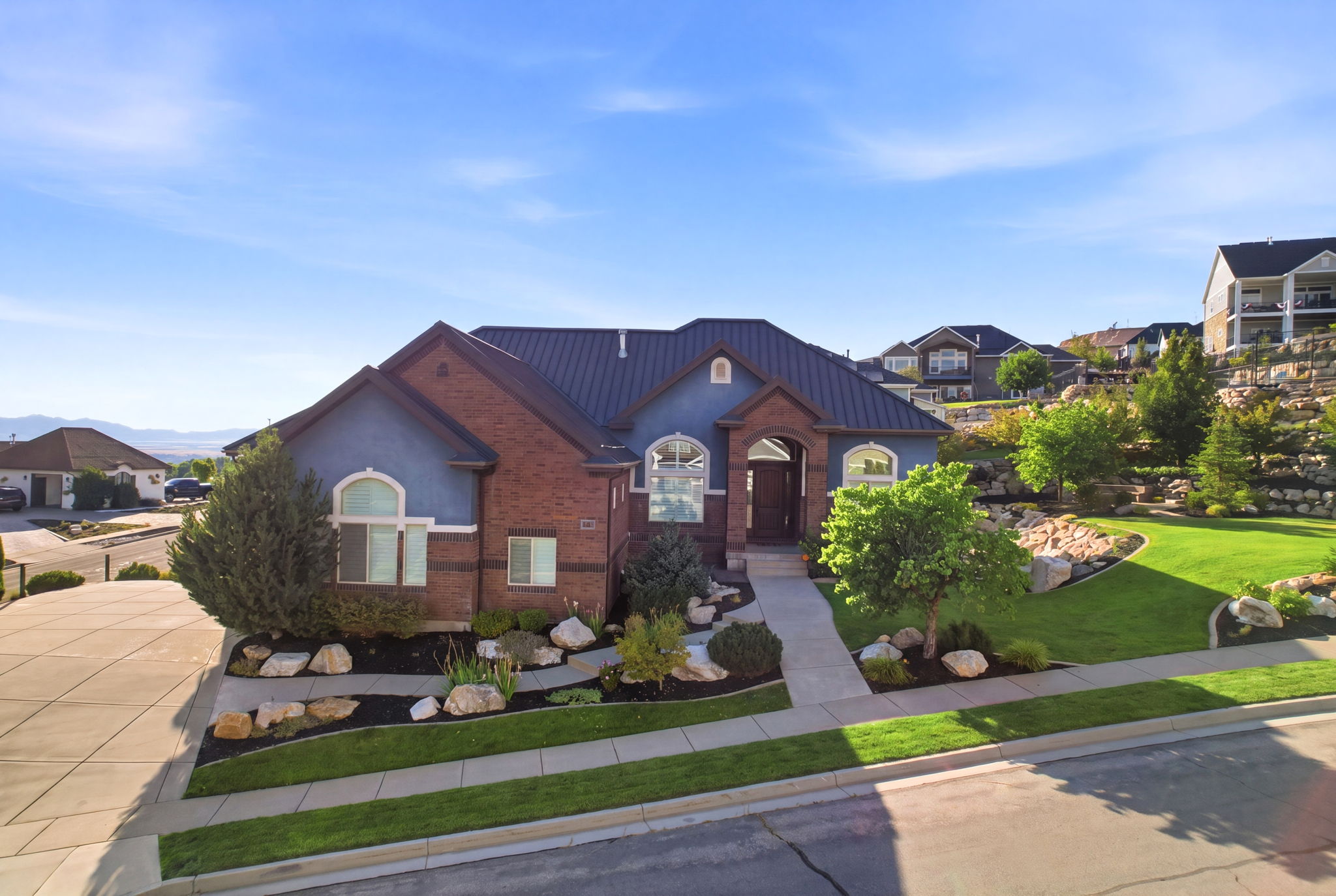 Brick and stucco exterior with a dark metal roof