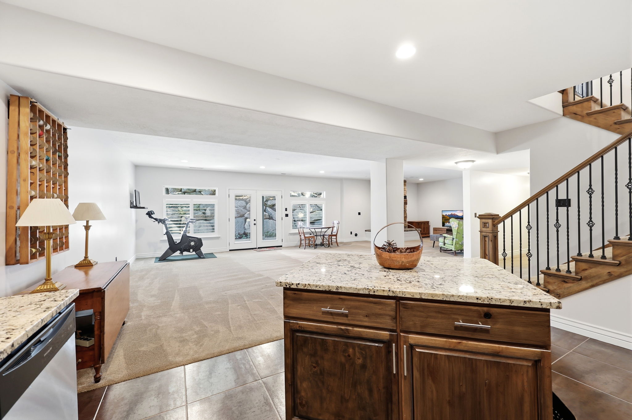 Kitchen island featuring a light-toned granite countertop and wood-finish cabinetry