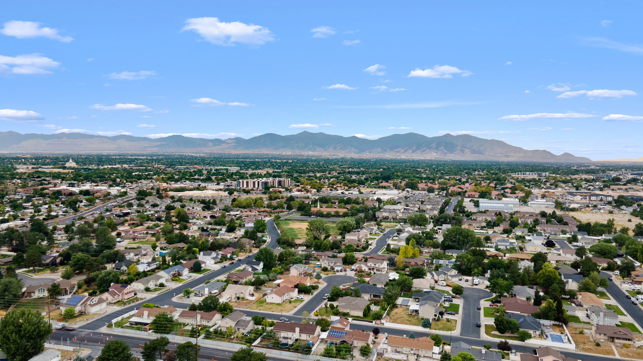Suburban landscape featuring a network of streets and residential properties