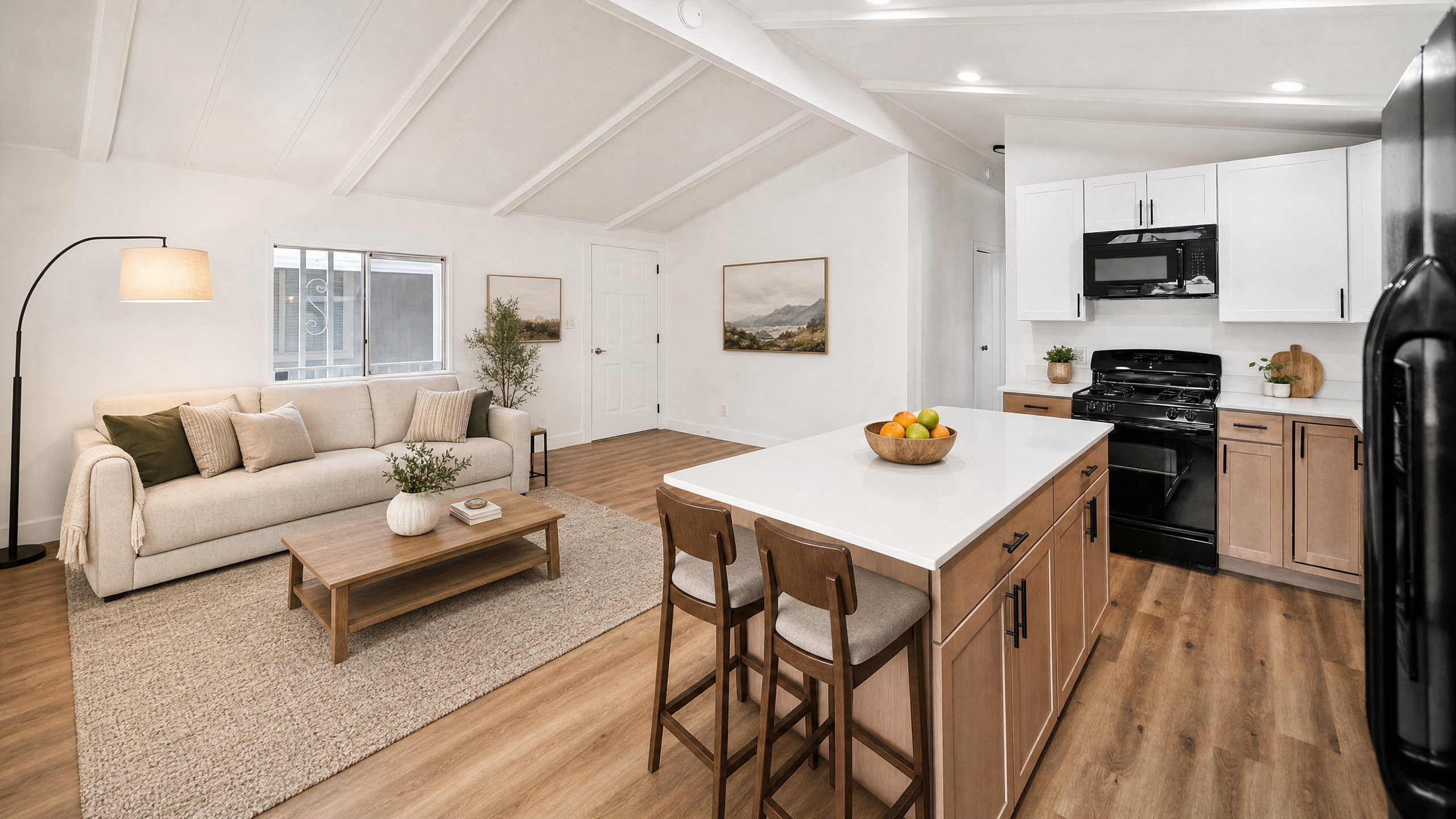Open-concept living area and kitchen featuring vaulted ceilings, wood-finish flooring, a kitchen island with seating, a white subway tile backsplash, and dark appliances