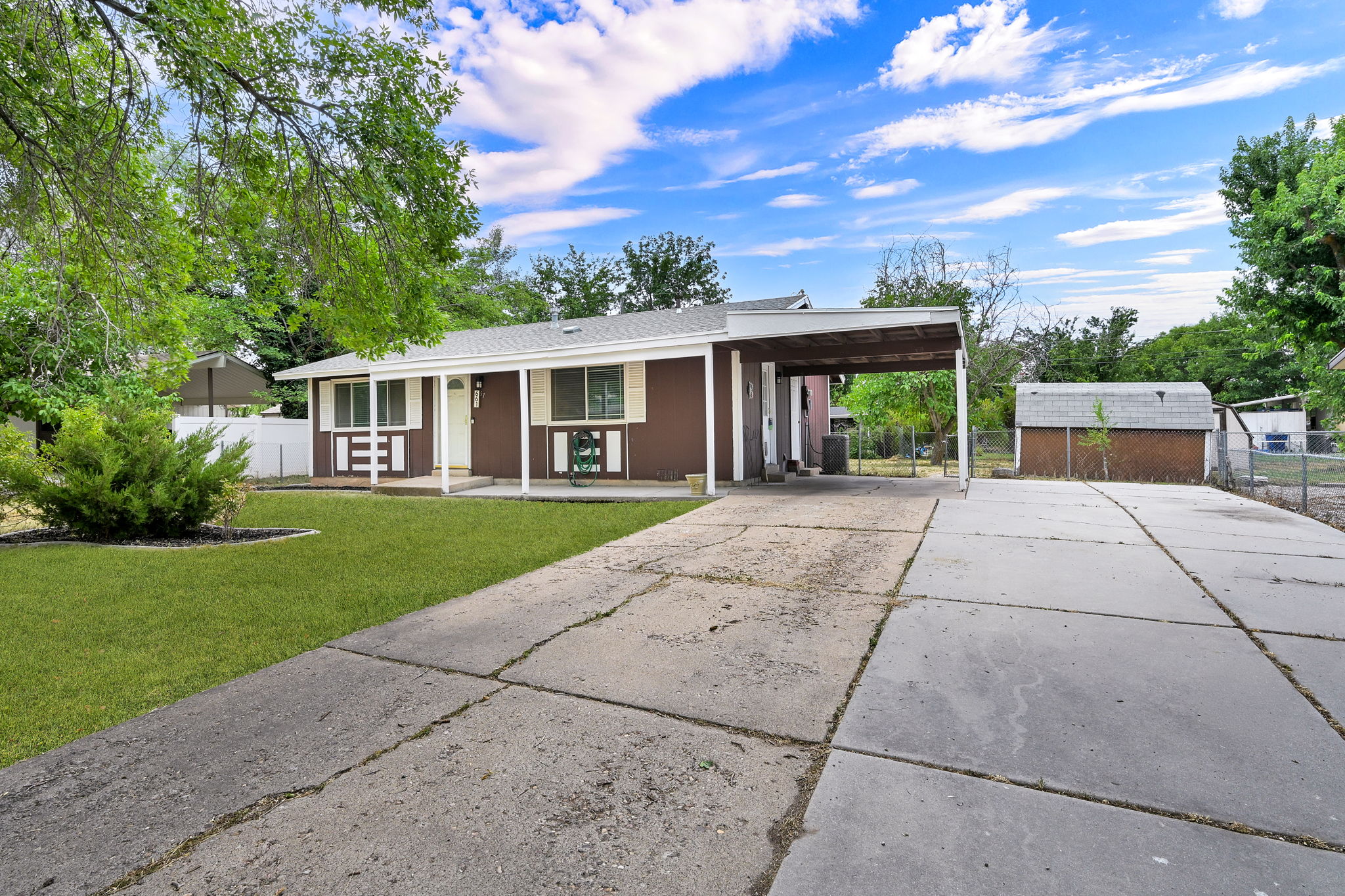 Single-story residence featuring a brown exterior with white trim