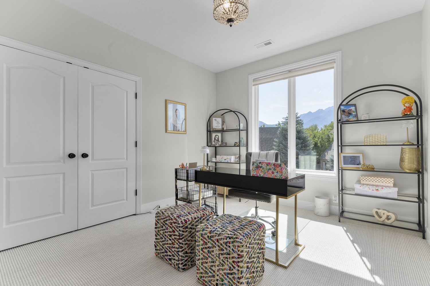 Room featuring a large window, light-colored carpeting, and a beaded semi-flush mount ceiling fixture