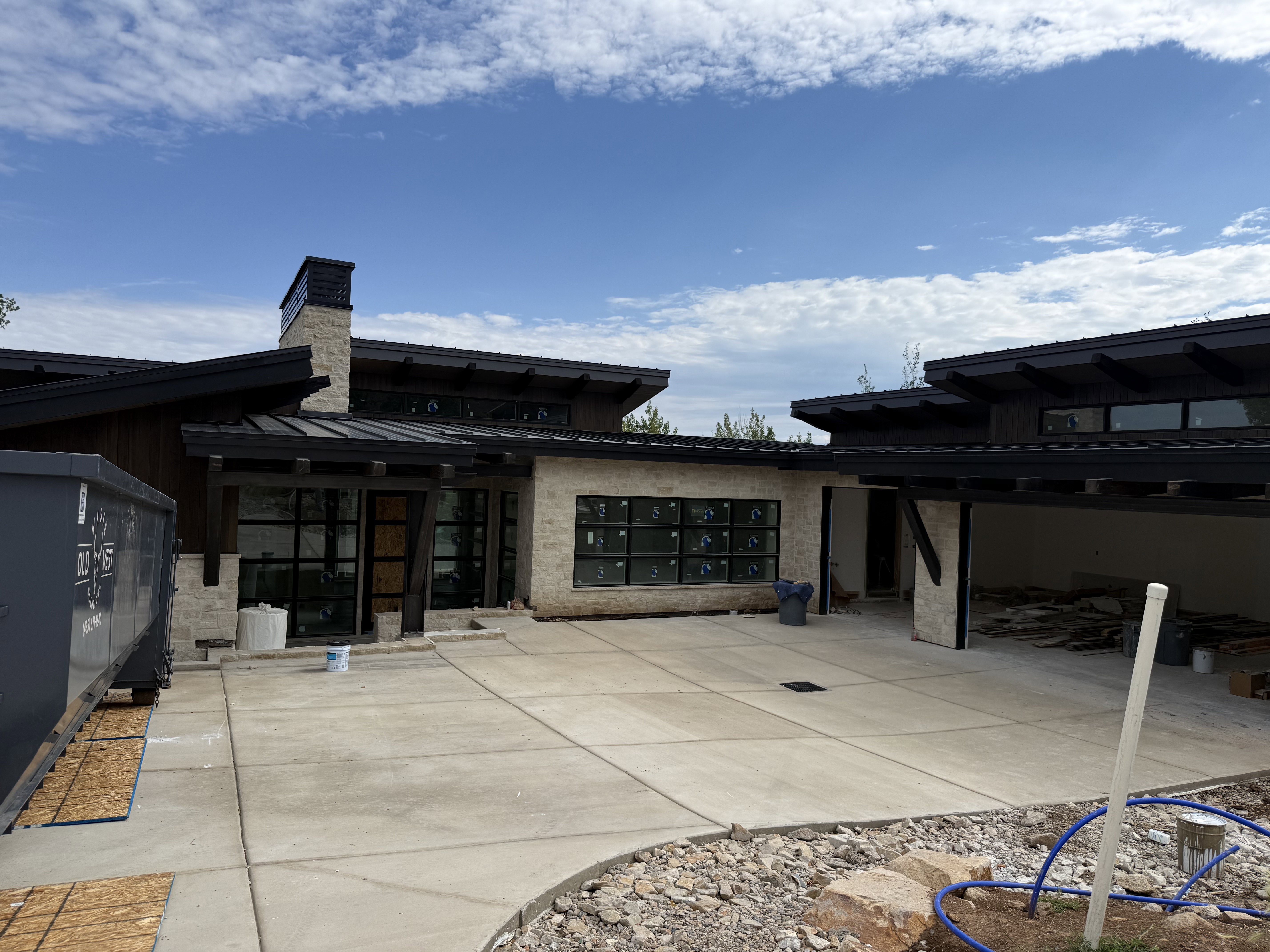 Modern architectural exterior featuring stone veneer and dark wood paneling